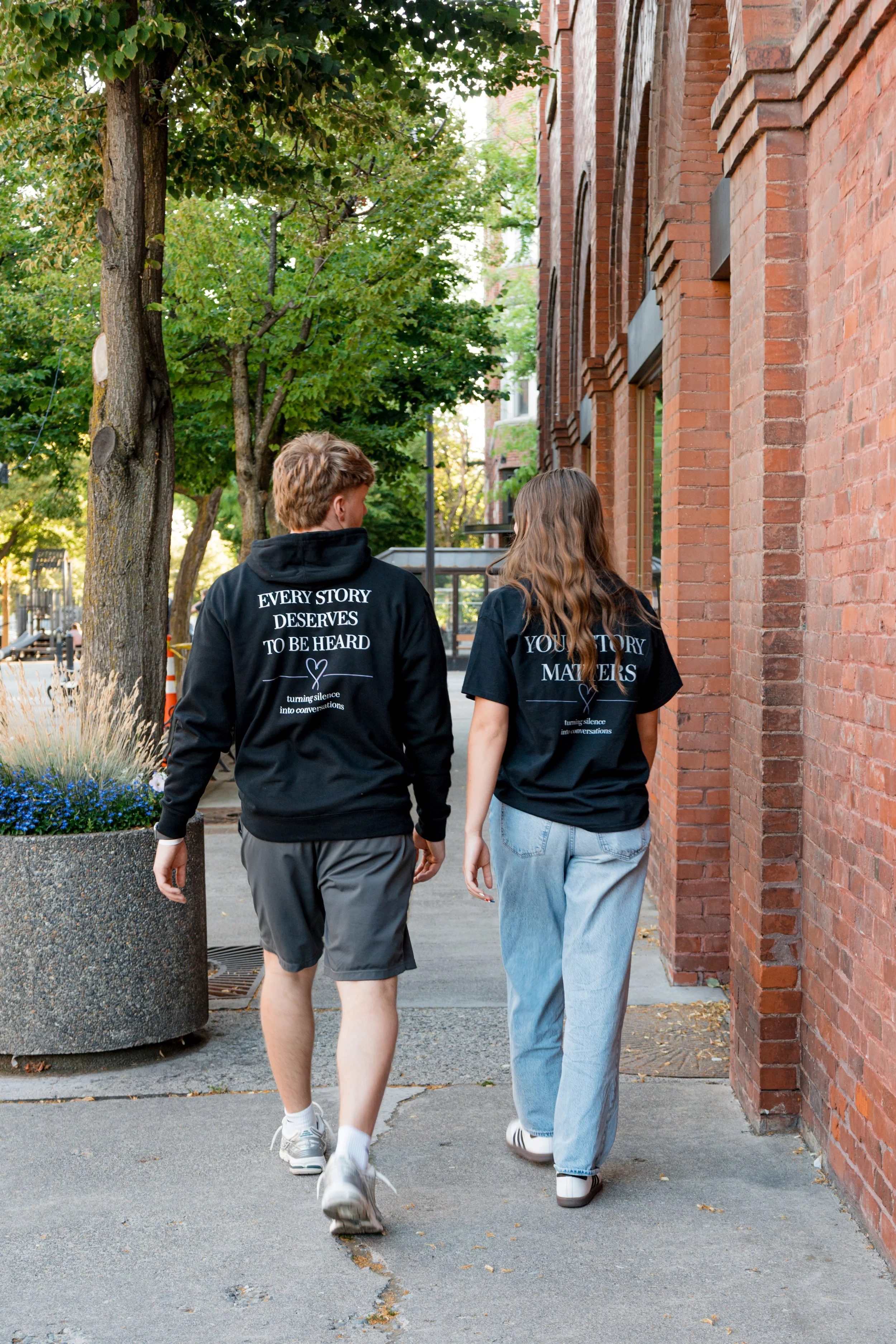Two people wearing StandUp33 awareness apparel while walking together.