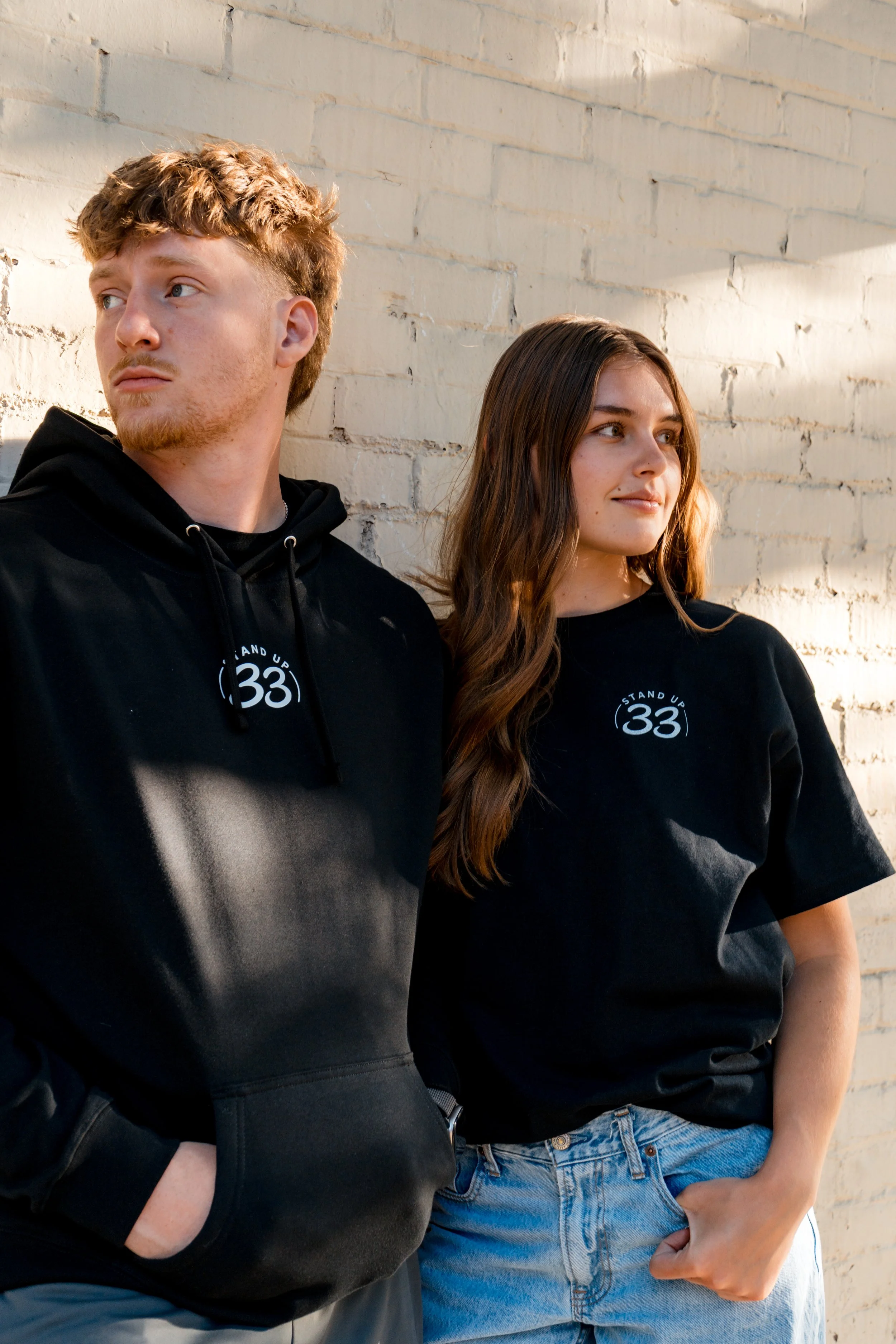 Two people wearing StandUp33 awareness apparel together.. 