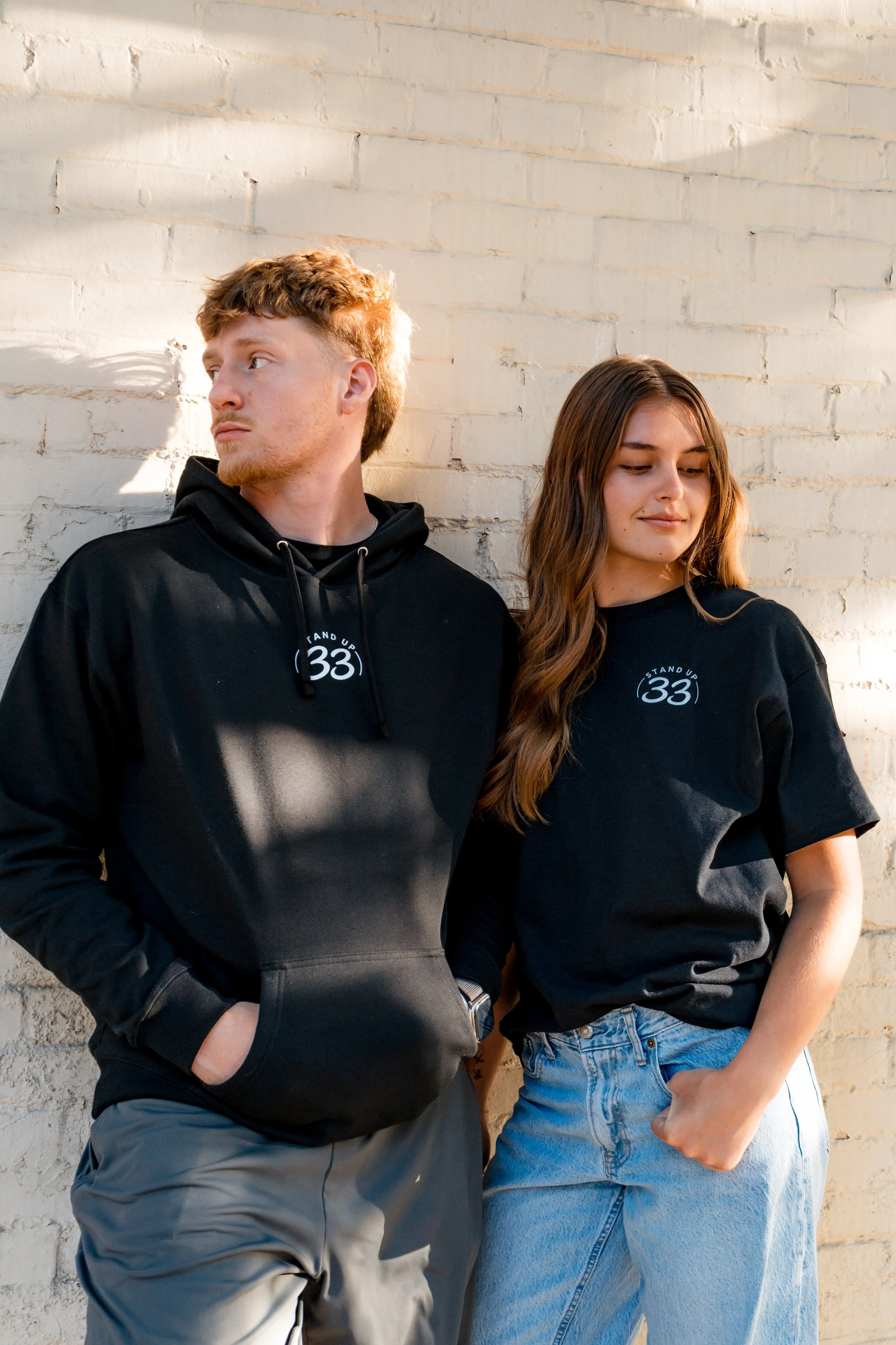 Two people wearing Standup33 awareness apparel that encourages difficult but necessary conversations. 