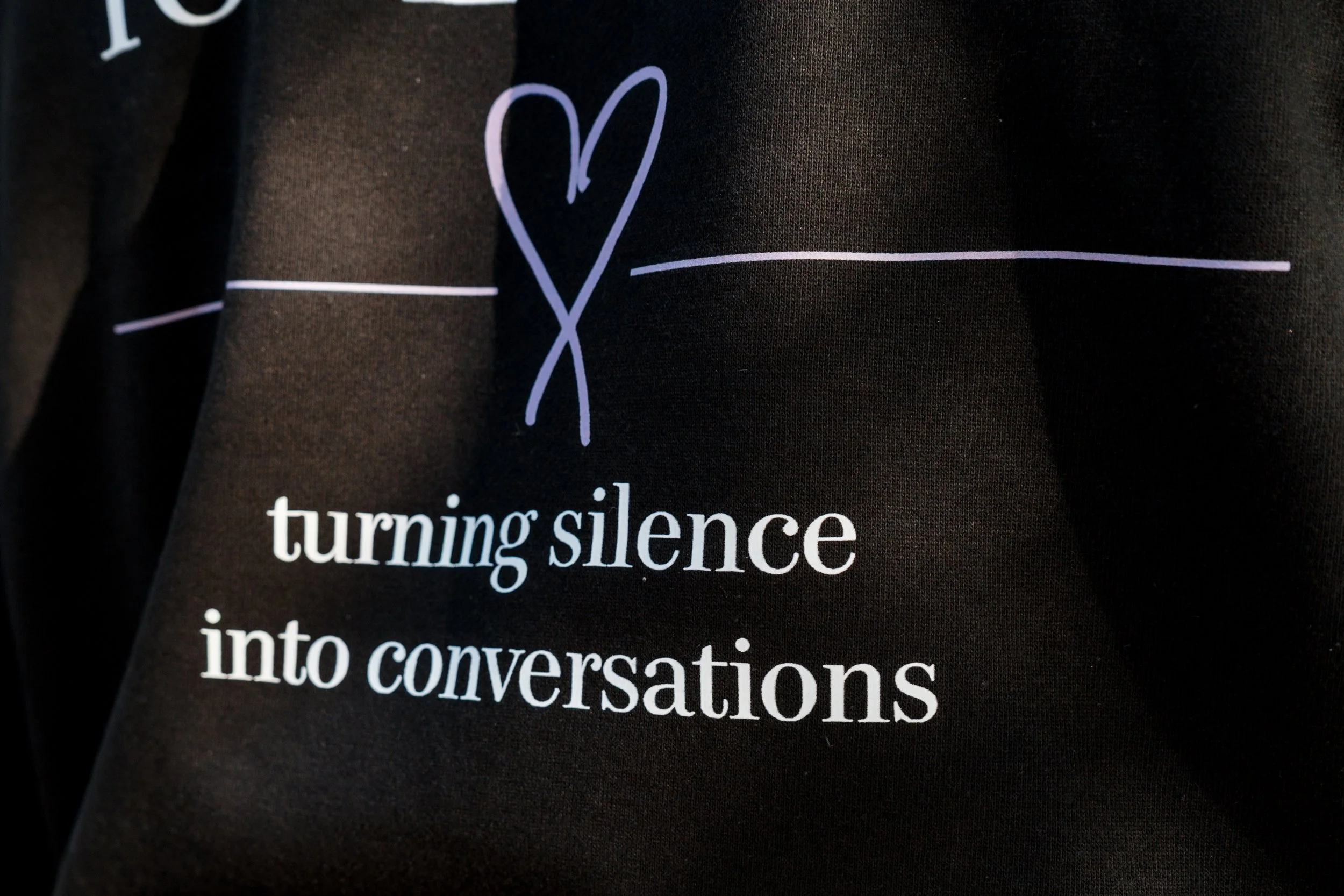 Close-up of the StandUp33 hoodie featuring a heart design and awareness message.