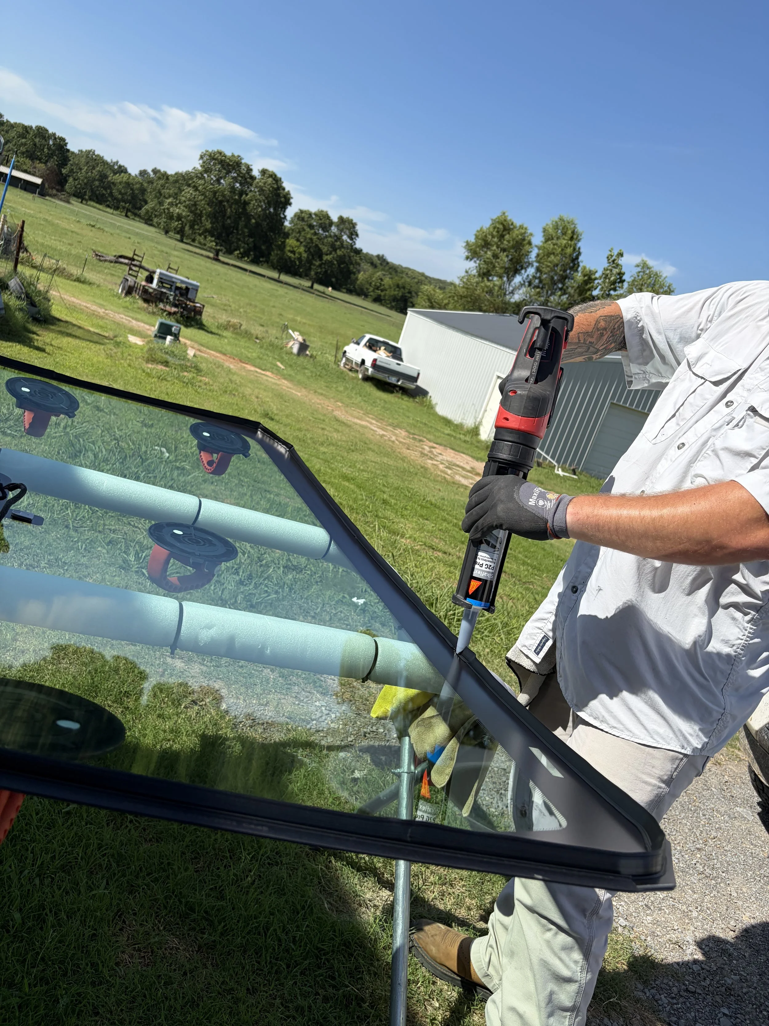 Urethane being applied to a windshield that is about to be installed in a truck.