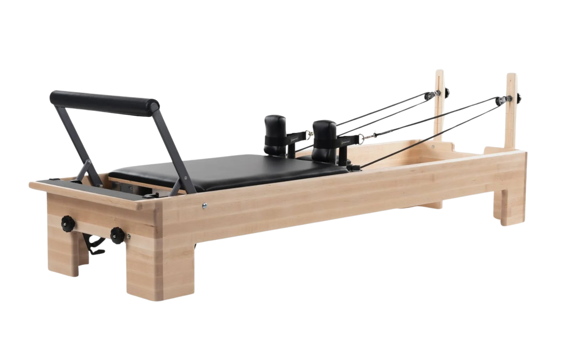 Wooden Pilates reformer with black padded platform, straps, pulleys, and headrest.