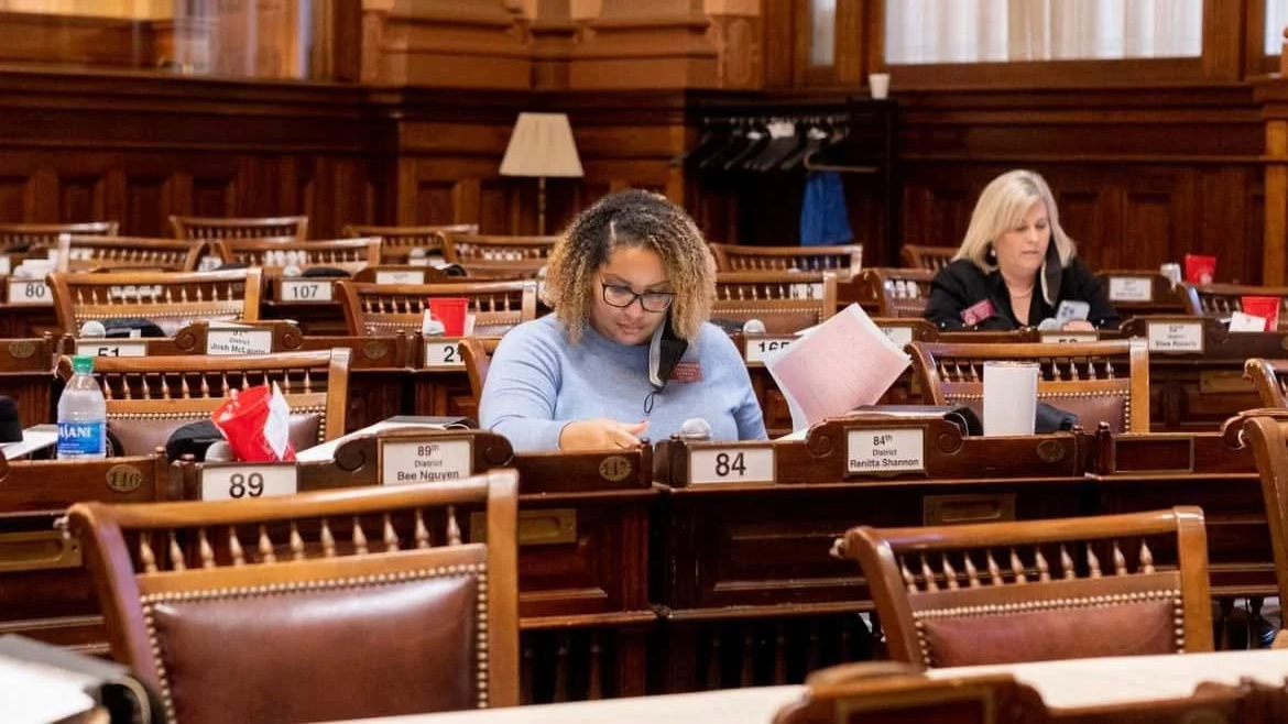 Rep. Renitta Shannon seated at her desk at the Georgia State Capitol.