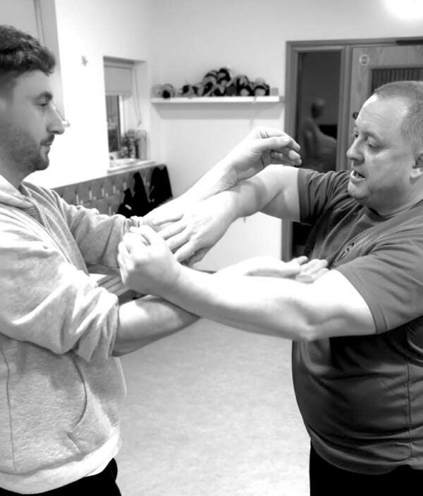 Two persons are practicing Wing Chun martial art at Gu-Jin Martial Arts in Stockton on Tees.