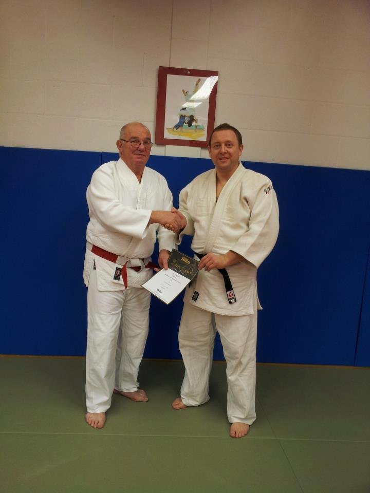 Instructor Alasdair Kirby receiving his 1st Dan Certificate from Fred Pilgrim 6th Dan