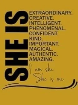 A yellow background with the word 'SHES' written vertically in large black letters. Next to it, in smaller black text, are positive adjectives: 'Extraordinary, Creative, Intelligent, Phenomenal, Confident, Kind, Important, Magical, Authentic, Amazing.' Below, handwritten in black ink, are the words 'I am she,' followed by 'She is me' with a decorative underline.