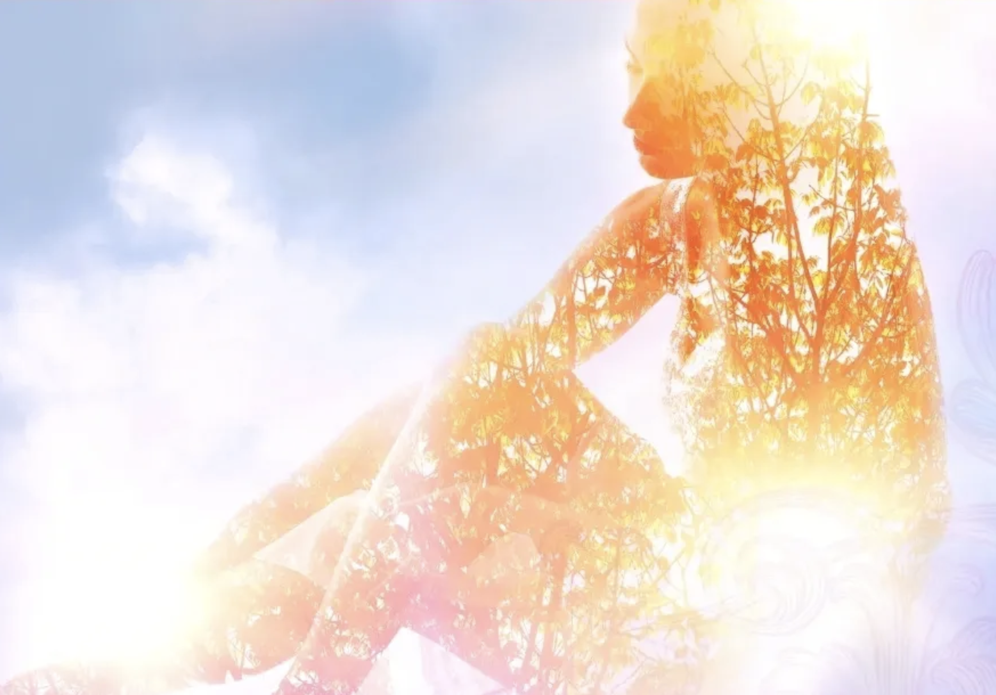 Double exposure photo of a woman and autumn trees against a blue sky with clouds.