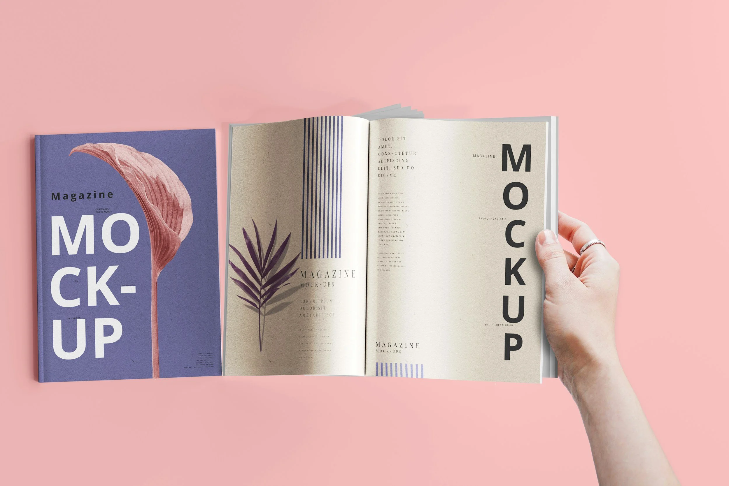 Two magazines on a pink surface, one closed with a purple cover featuring a pink leaf illustration and the word "Magazine" in black, and one open showing a two-page spread with text and graphic elements, a hand with a silver ring holding the open magazine.