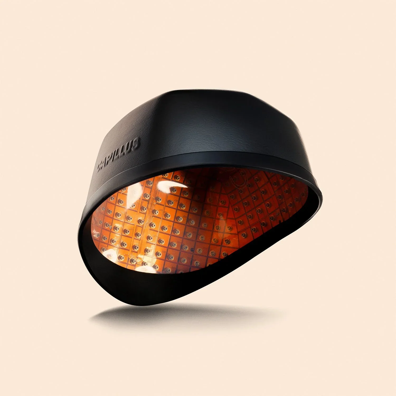 Close-up of a black LED curing light with orange interior and multiple small LEDs arranged in a grid pattern.