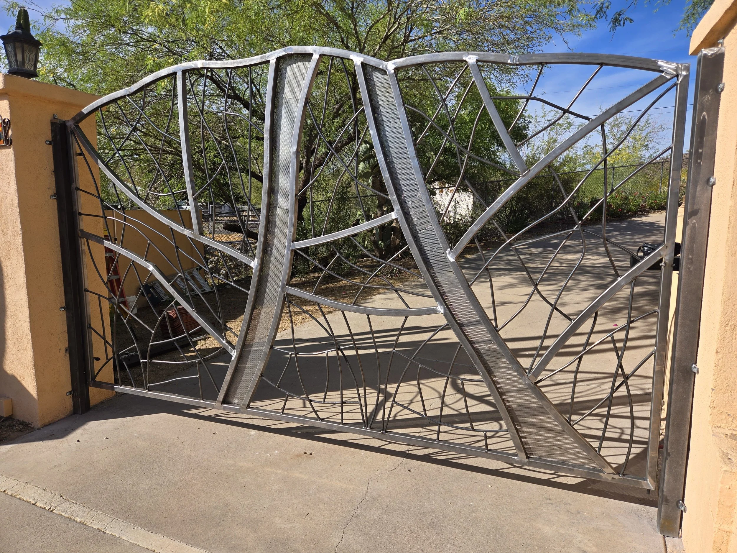 Custom steel driveway gate on a desert property, Phoenix metal fabrication