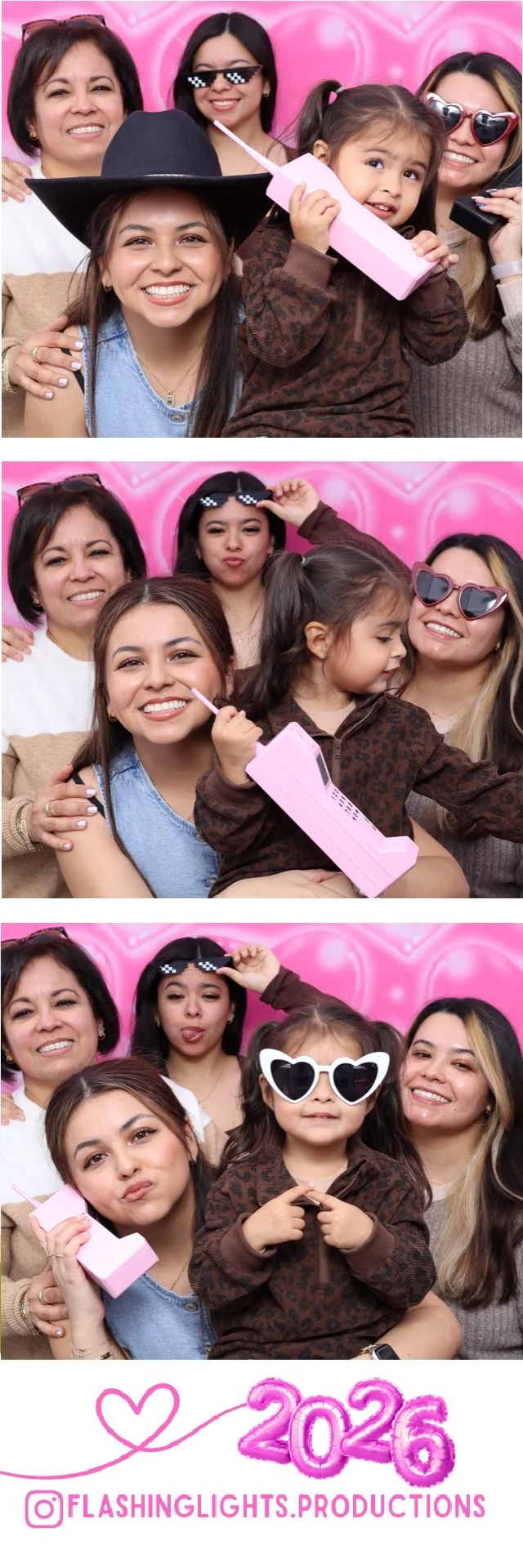 A group of five women and a young girl taking playful photos in front of a pink heart-shaped balloon backdrop. The women are wearing sunglasses and making silly faces, while the girl is holding a pink toy telephone. The bottom of the image features pink balloon numbers reading '2026' and an Instagram handle '@FLASHINGLIGHTS.PRODUCTIONS'.