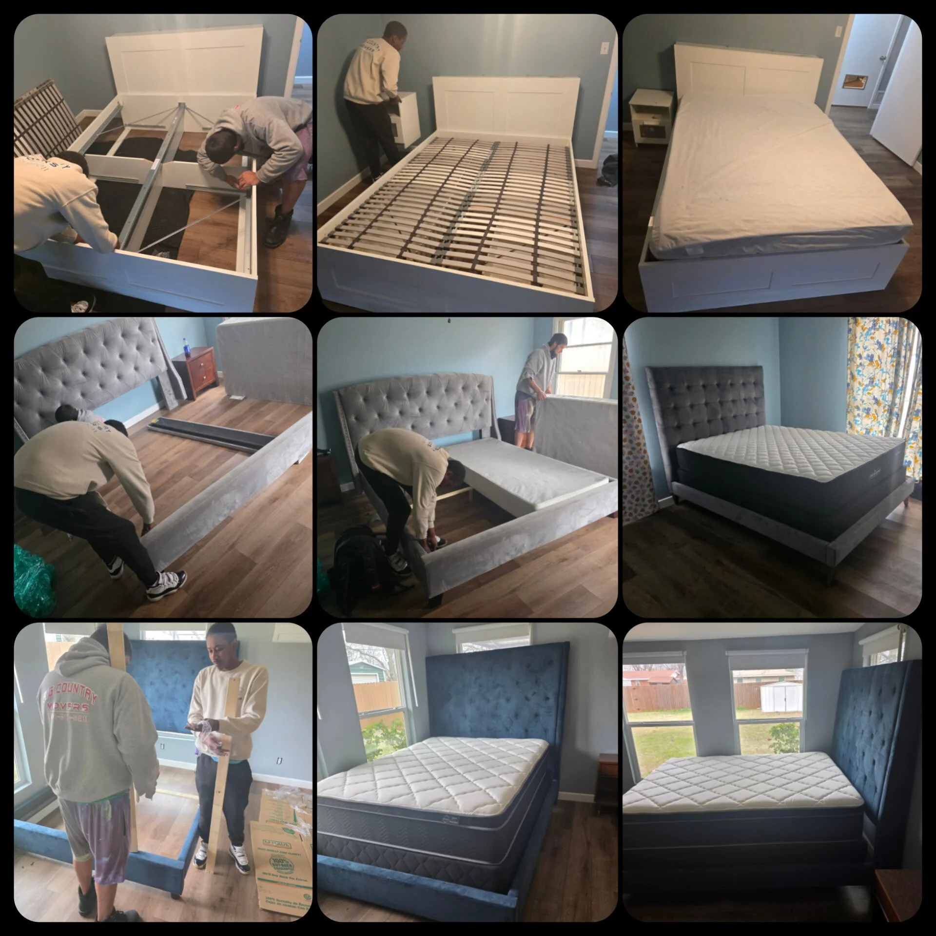 People assembling and setting up a bed frame and mattress in a bedroom. The room has light blue walls, wooden flooring, and large windows.