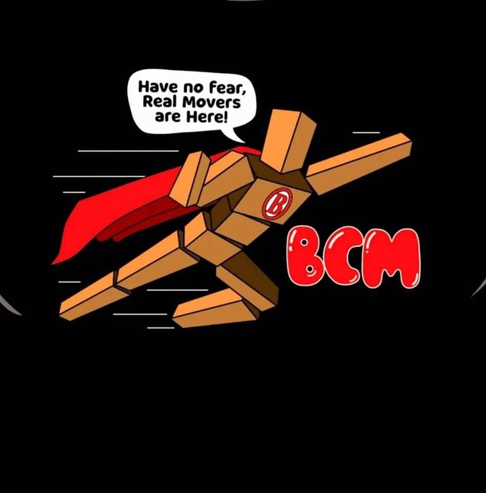 A cartoon wooden figure dressed as a superhero with a red cape, a circle on its chest with a 'B' symbol, flying against a black background. The figure is speaking a speech bubble that says, 'Have no fear, Real Movers are Here!' The text 'BCM' is in red letters next to the figure.