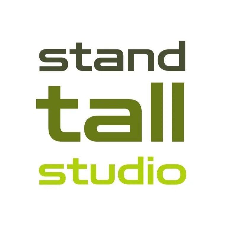 Logo for Stand Tall Studio with the words 'stand', 'tall', and 'studio' in different shades of green and gray