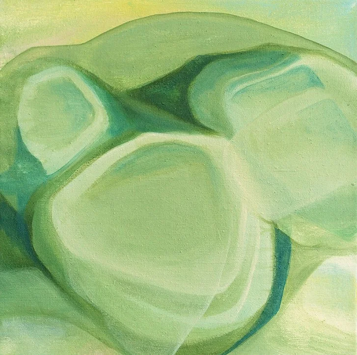 Close-up of an abstract green and light yellow painting with rounded shapes.