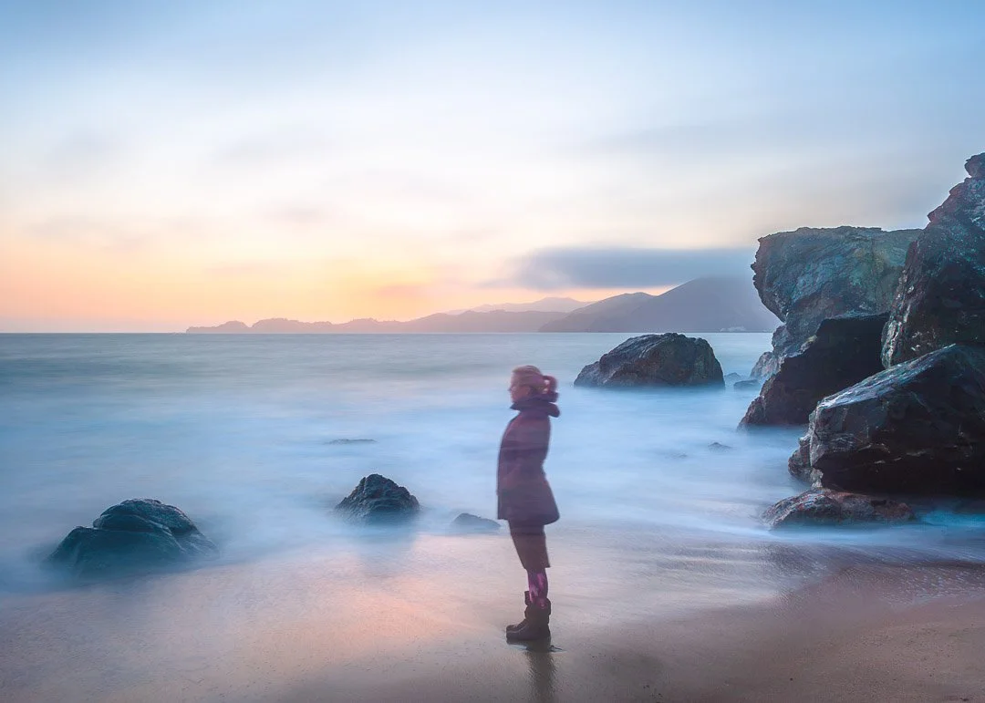 Long exposure portrait of the artist on the beach.