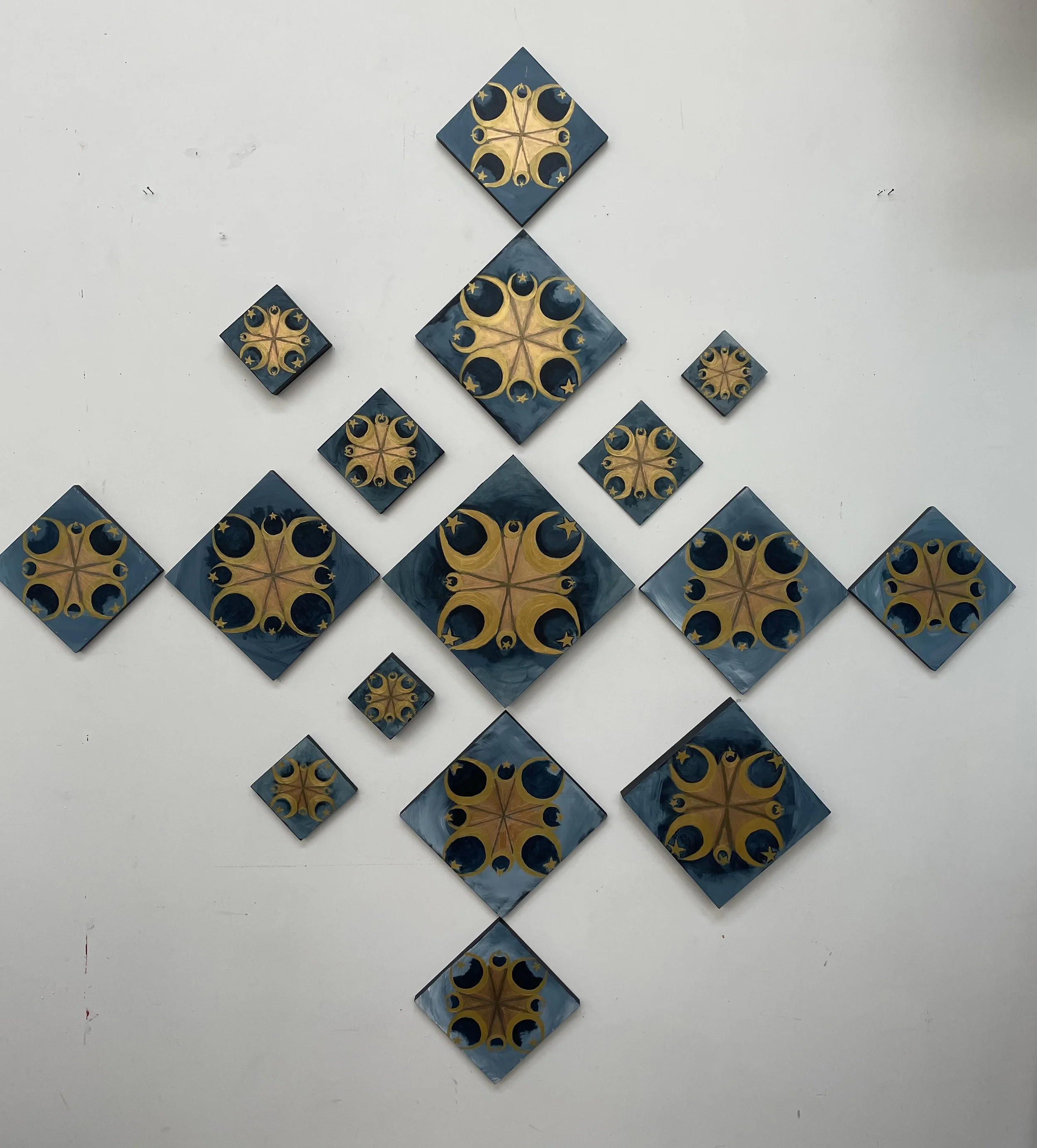 "Muhammad's Crescent and Star" Sixteen paintings on wooden blocks. Ranging from two inches square to six inches square. Gold symbols painted on a dark blue background.