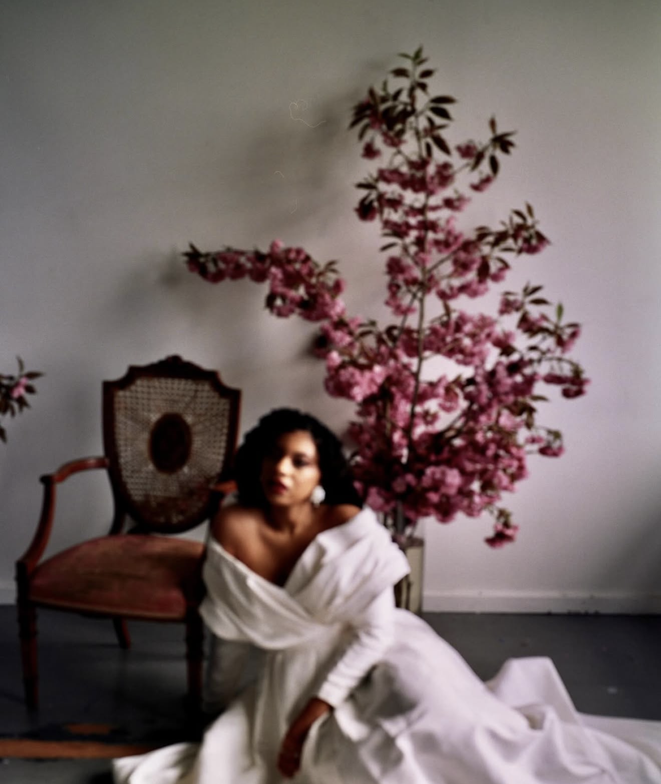 Bride in front of a large cherry blossom arragement