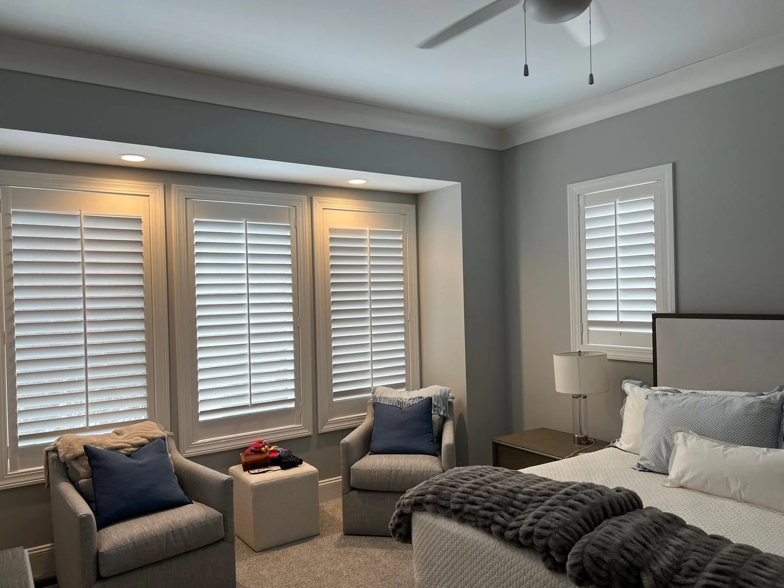 White plantation shutters in a living room — custom window treatments by Rose CWT, Northeast Ohio