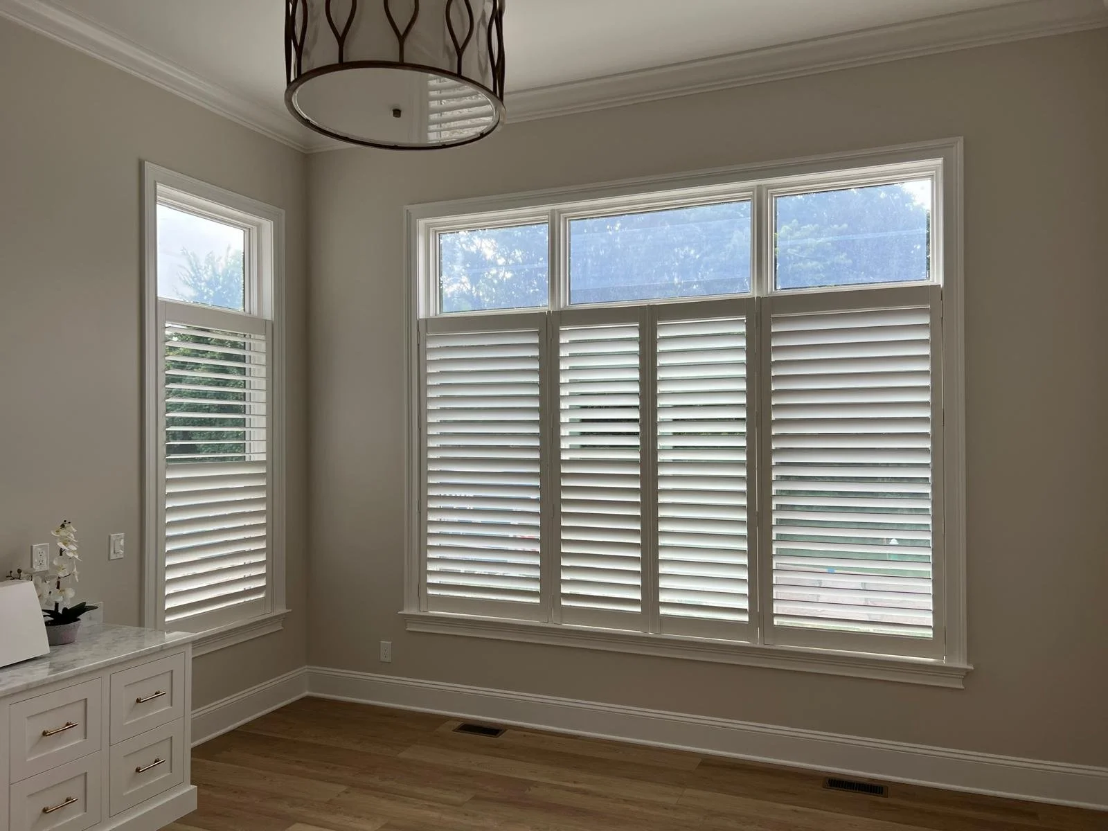 Interior room with custom-fitted plantation shutters installed by Rose CWT in Ohio