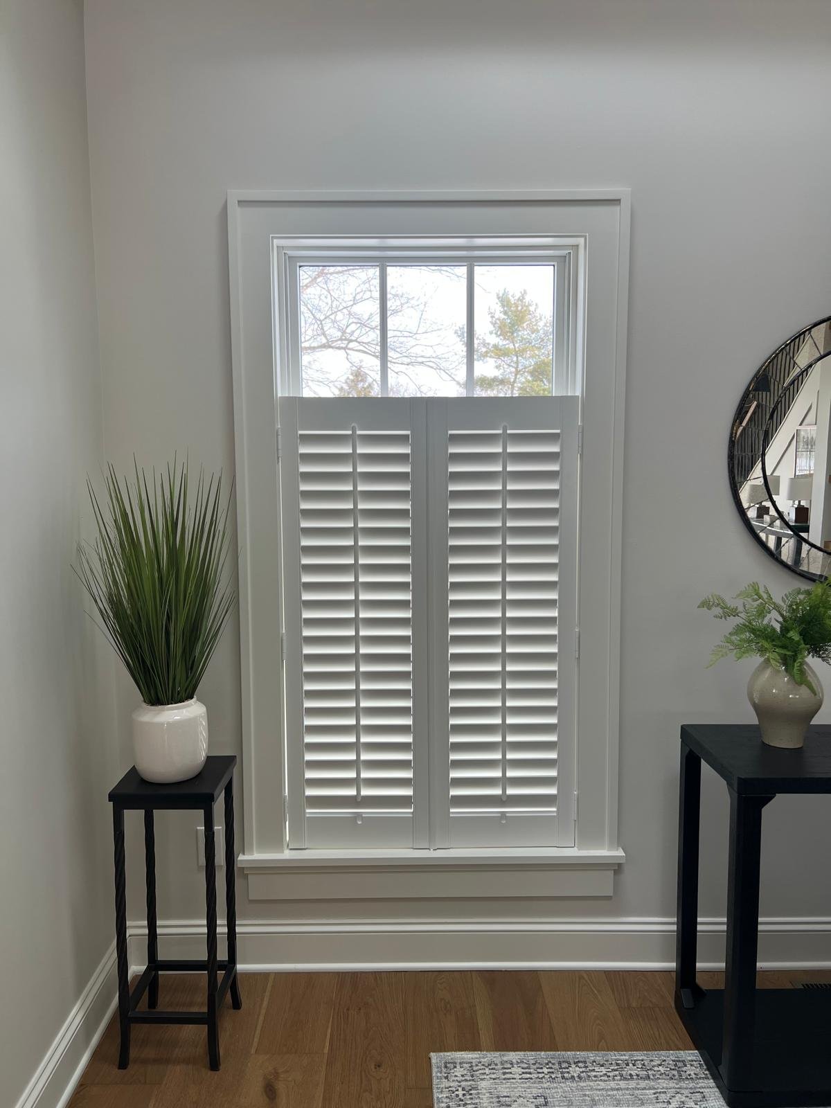 Custom plantation shutters in a bright living room — Rose CWT Cleveland Ohio