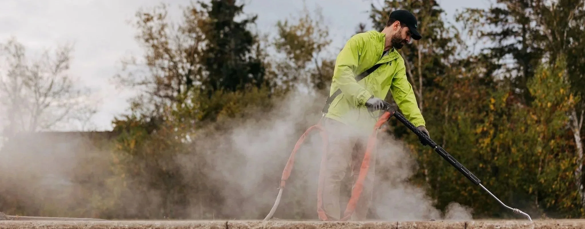 Element Landscape Solutions operator applying Satusteam weed control to a rack garden for a restaurant in Moncton NB