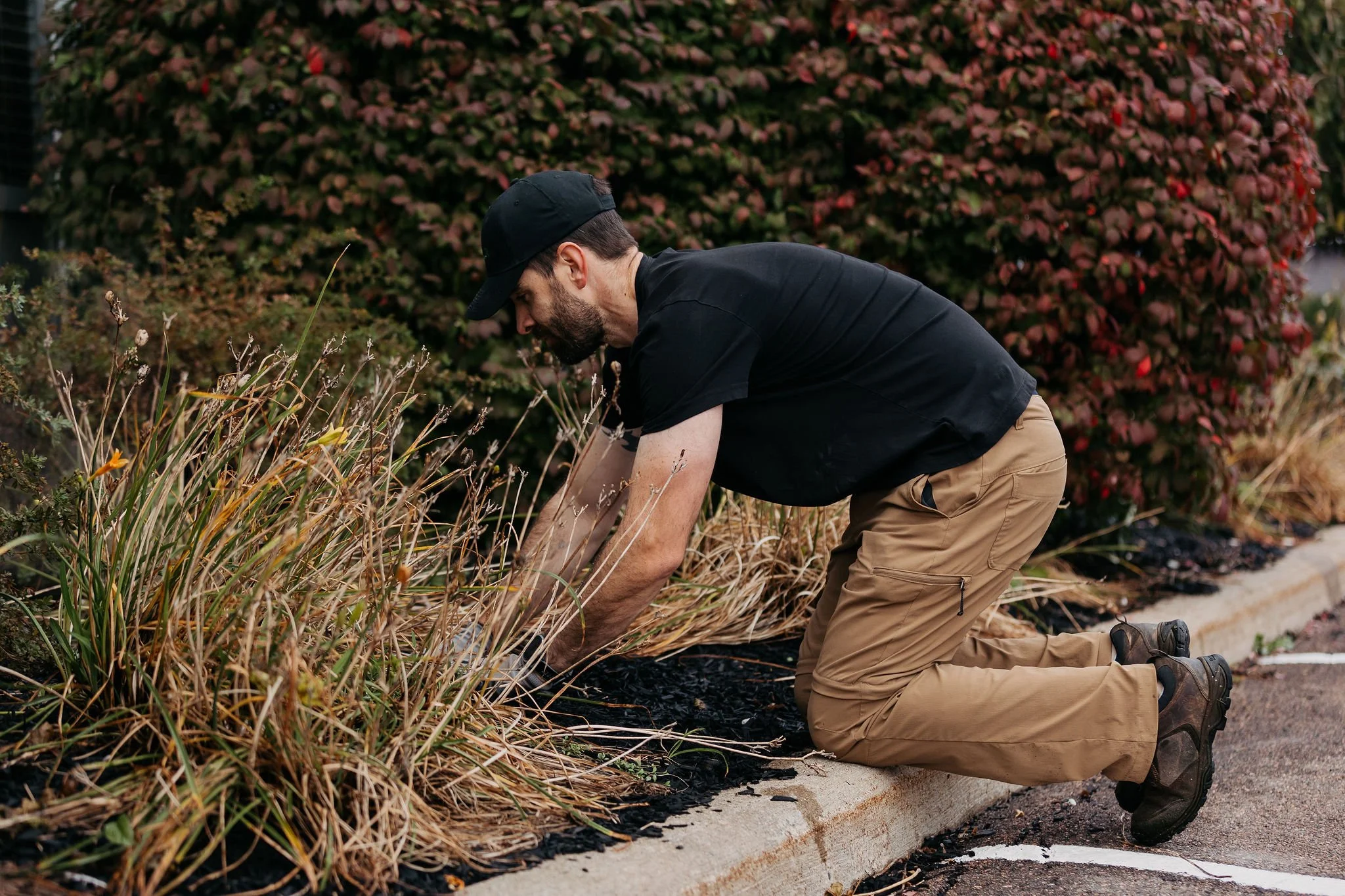 Element Landscape Solutions technician planting garden bed with HydroSoilRevive soil amendment in Moncton, NB