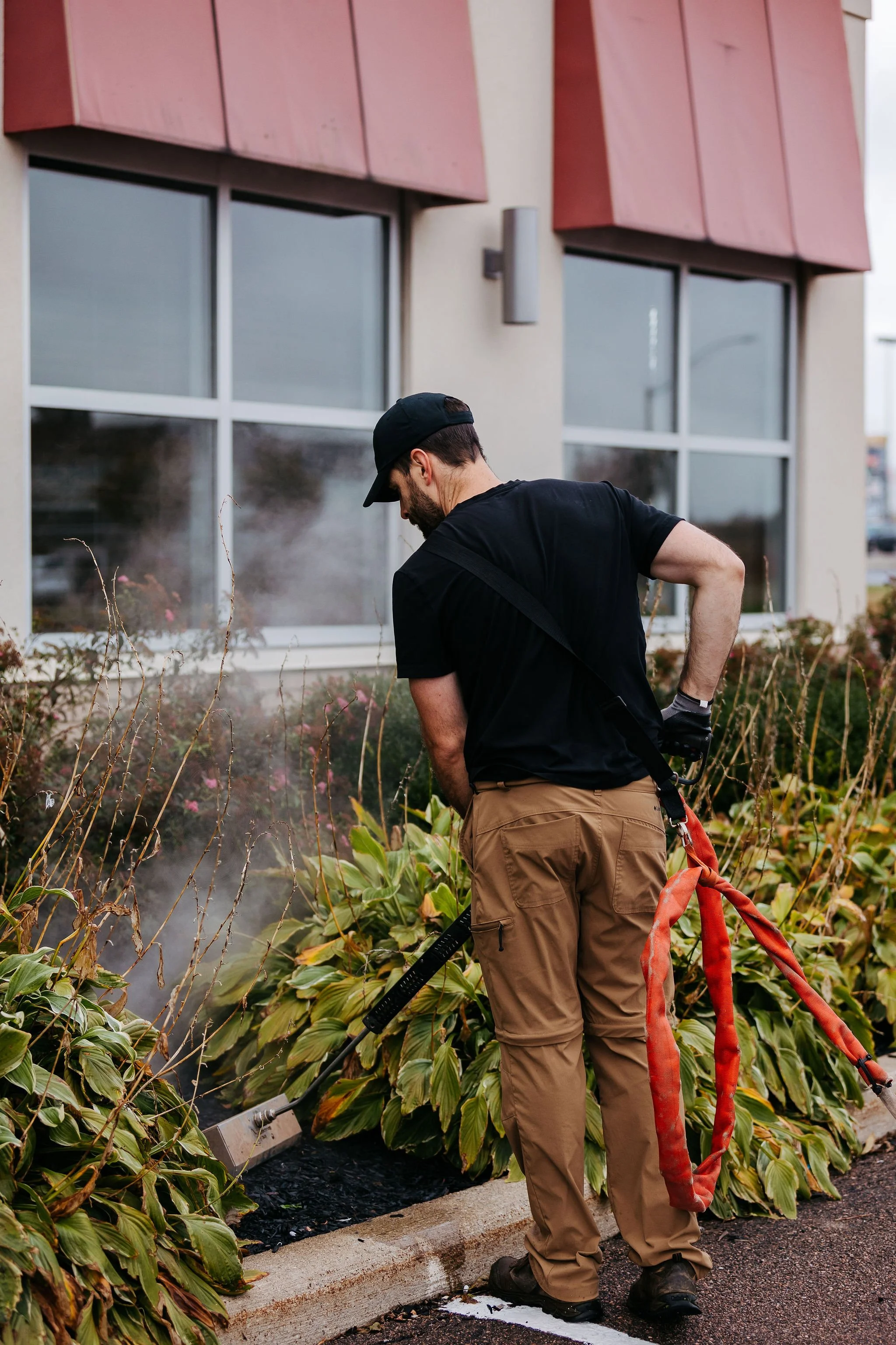 Chemical-free Satusteam weed control being applied to a garden bed in Moncton, NB