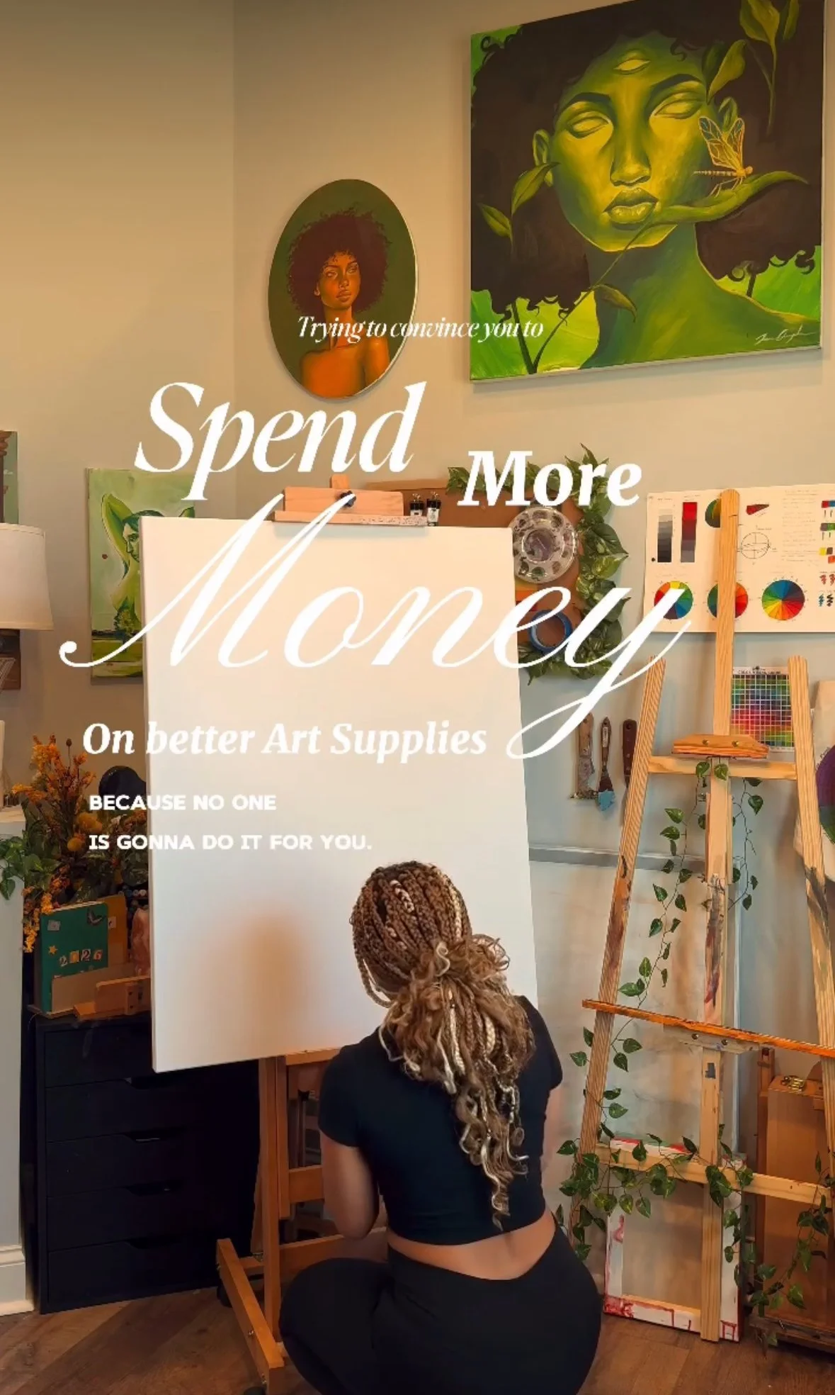 A person with braided hair is kneeling in front of a blank canvas on an easel, ready to paint. The room is decorated with plants, art supplies, and paintings on the wall, with a ladder and shelves filled with art materials. Overlaid on the image is text that reads, 'Trying to convince you to Spend More Money on better Art Supplies BECAUSE NO ONE IS GONNA DO IT FOR YOU.'