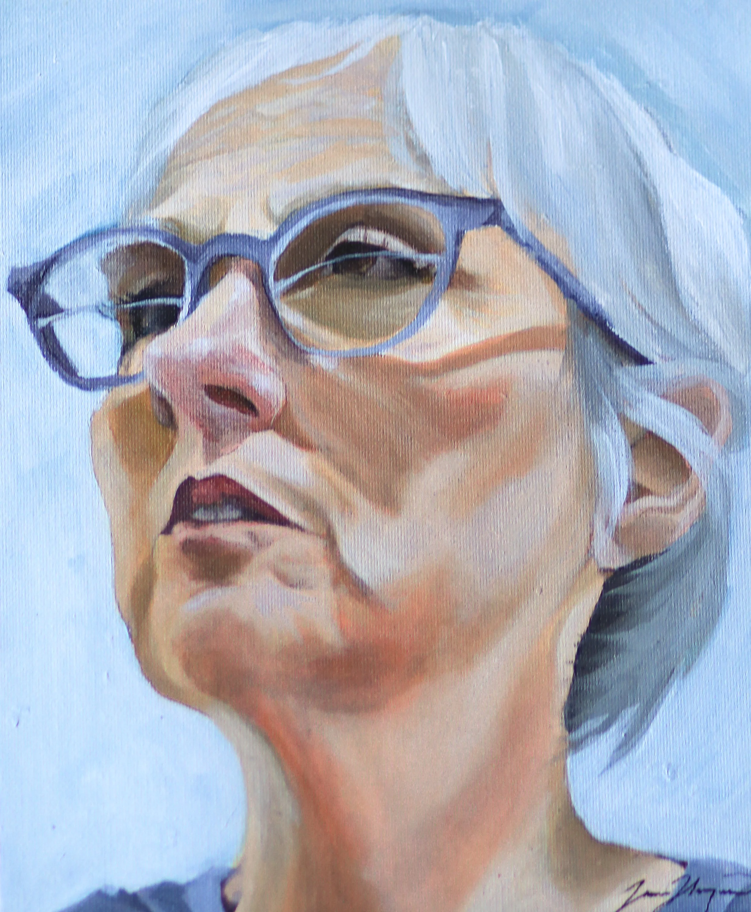 A person with long white hair, wearing blue glasses and a white shirt, is smiling and appears to be happy.