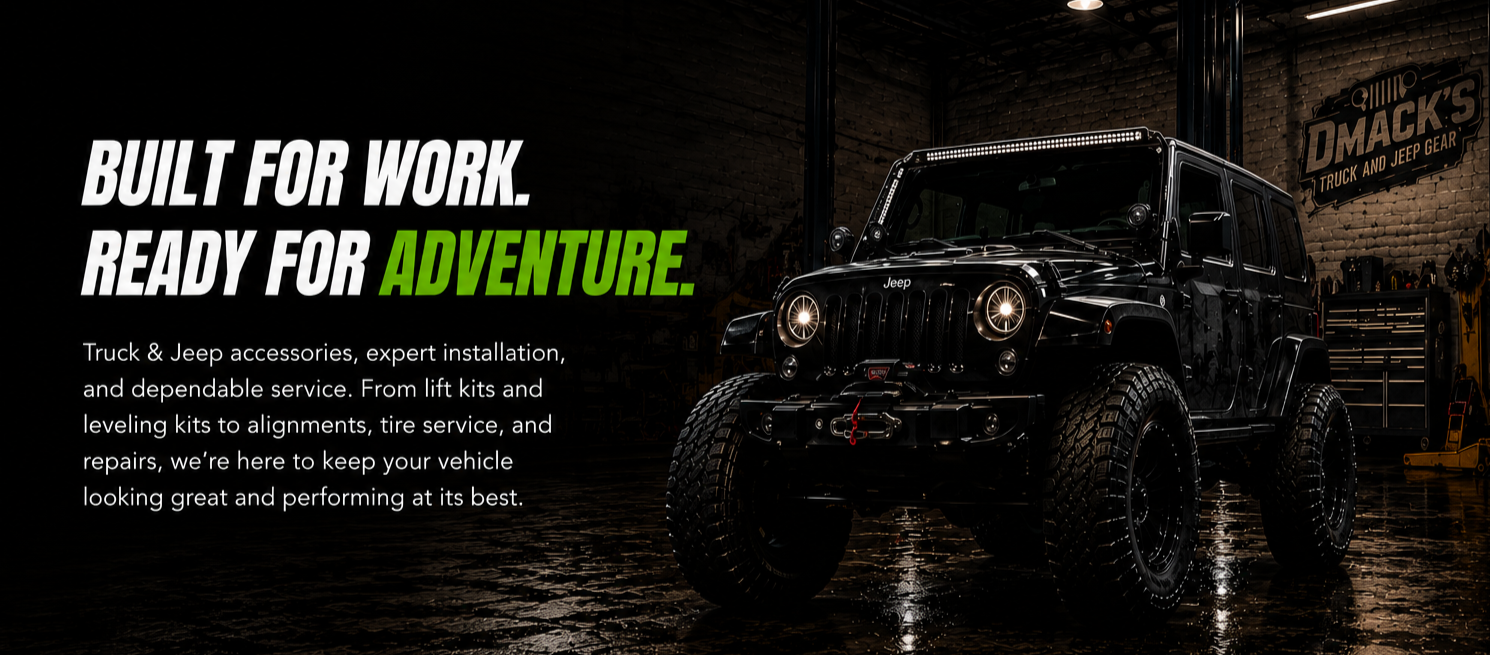 A black Jeep vehicle parked inside a workshop with a sign on the wall reading 'DMACK'S Truck and Jeep Gear'. The Jeep has large off-road tires, bright headlights, and a red tow hook on the front bumper. The workshop has tools and equipment in the background. The overlay text promotes Truck & Jeep accessories, installation, and service.
