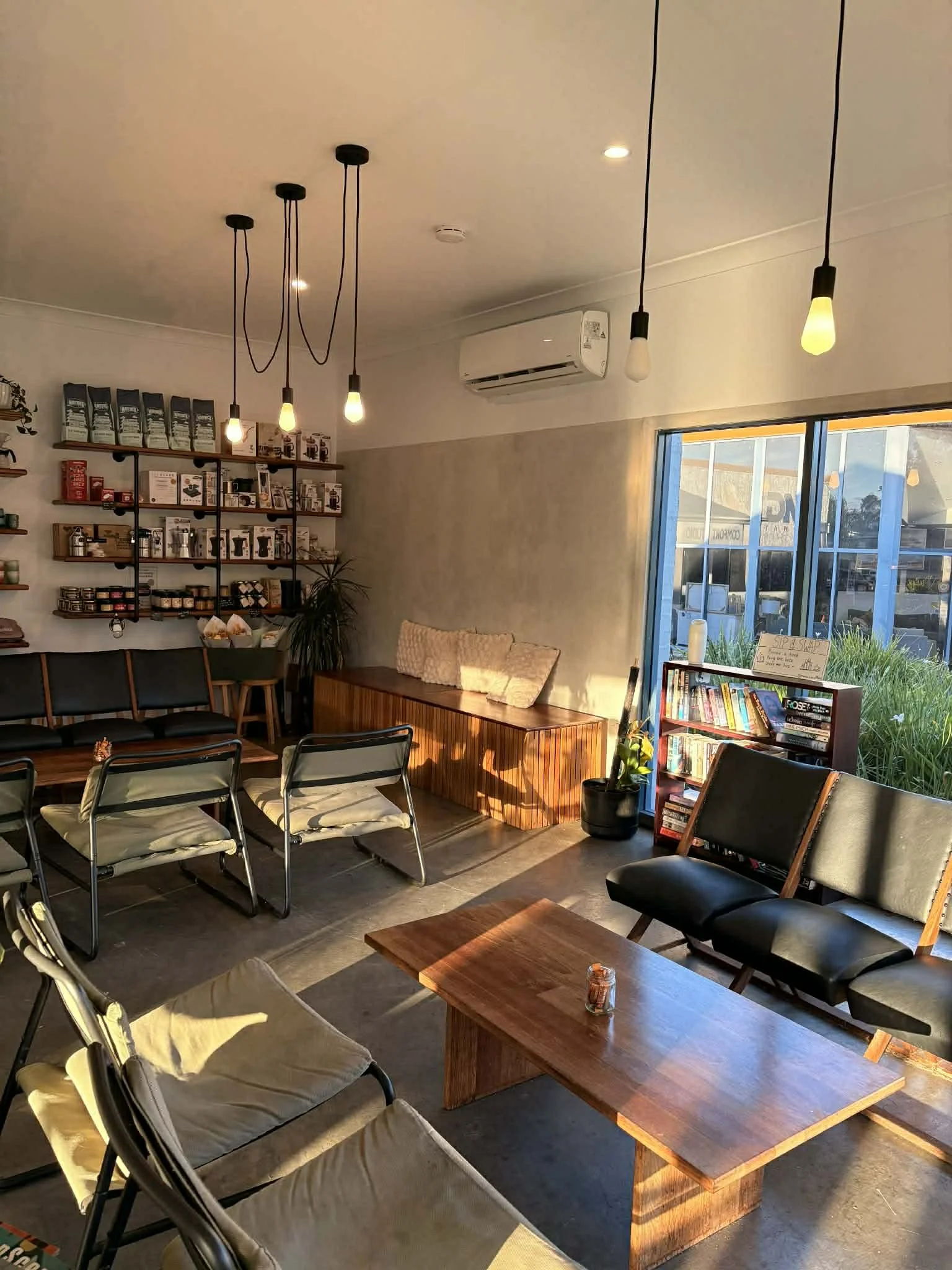 Cosy warm space showing glowing morning sun, comfortable coffee shop