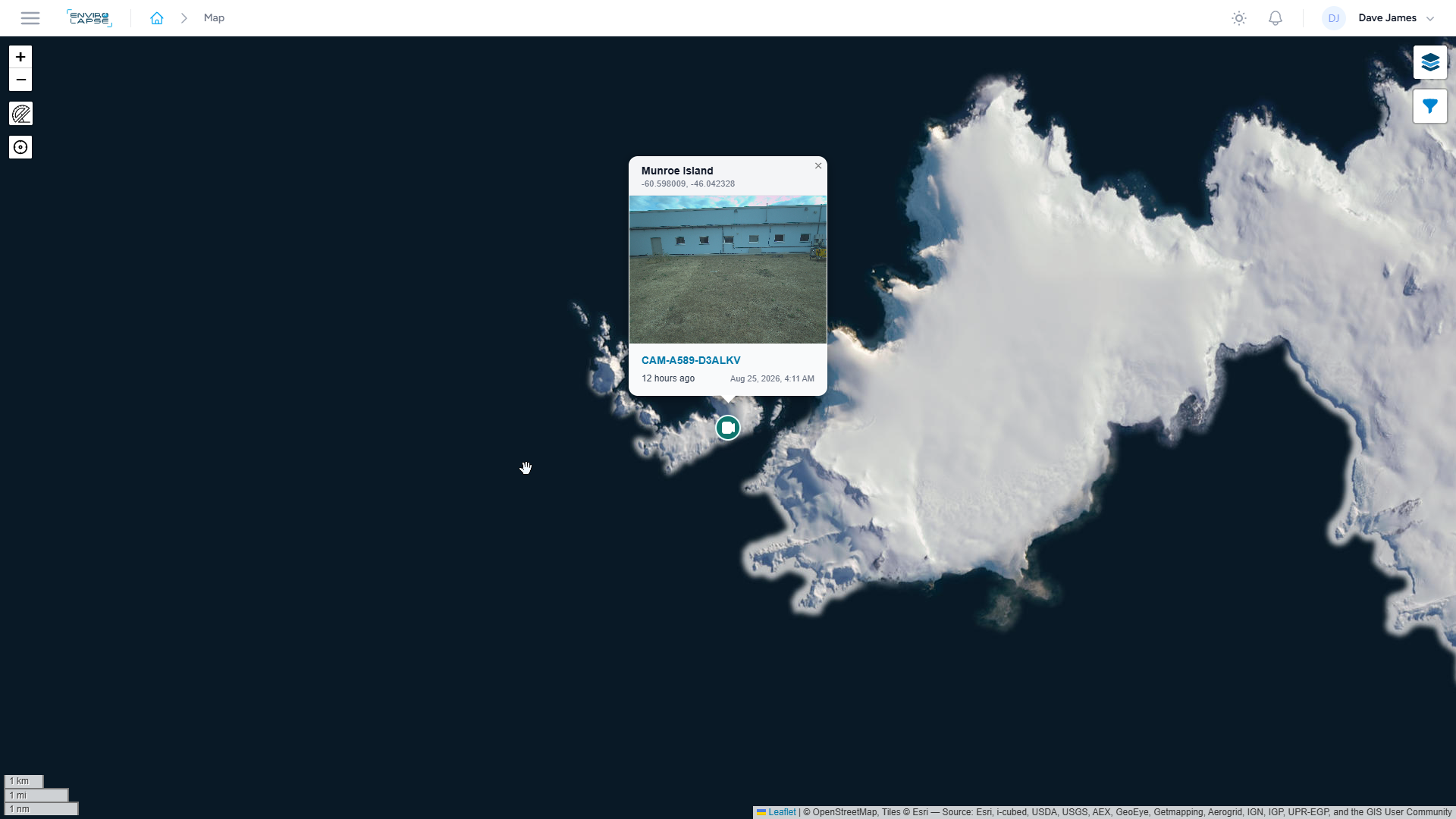 Interactive digital map of Antarctica showing a photo of Munroe Island and its coordinates with navigation options on the side.