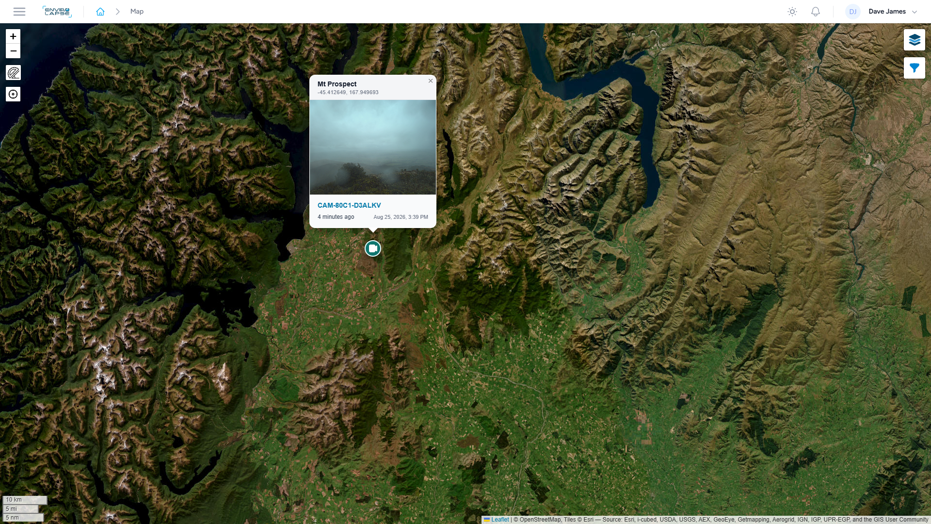 Satellite map showing mountainous terrain, water bodies, and a location marker for Mount Prospect with a small weather-related photo attached.