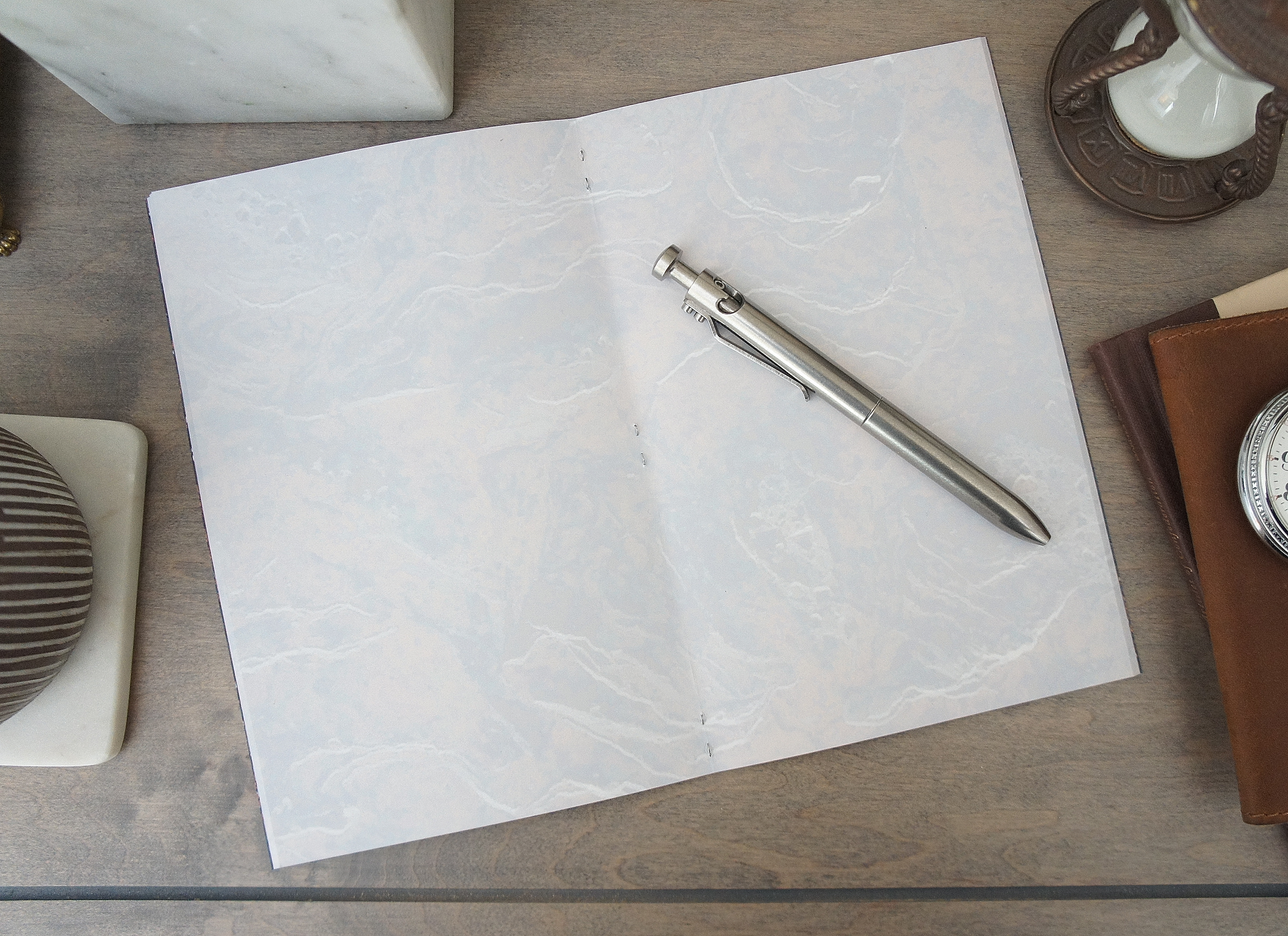 The texture of stone covers the inside of a 5 inch by 7 inch softcover journal, handmade in New London, New Hampshire by the Munk Mint