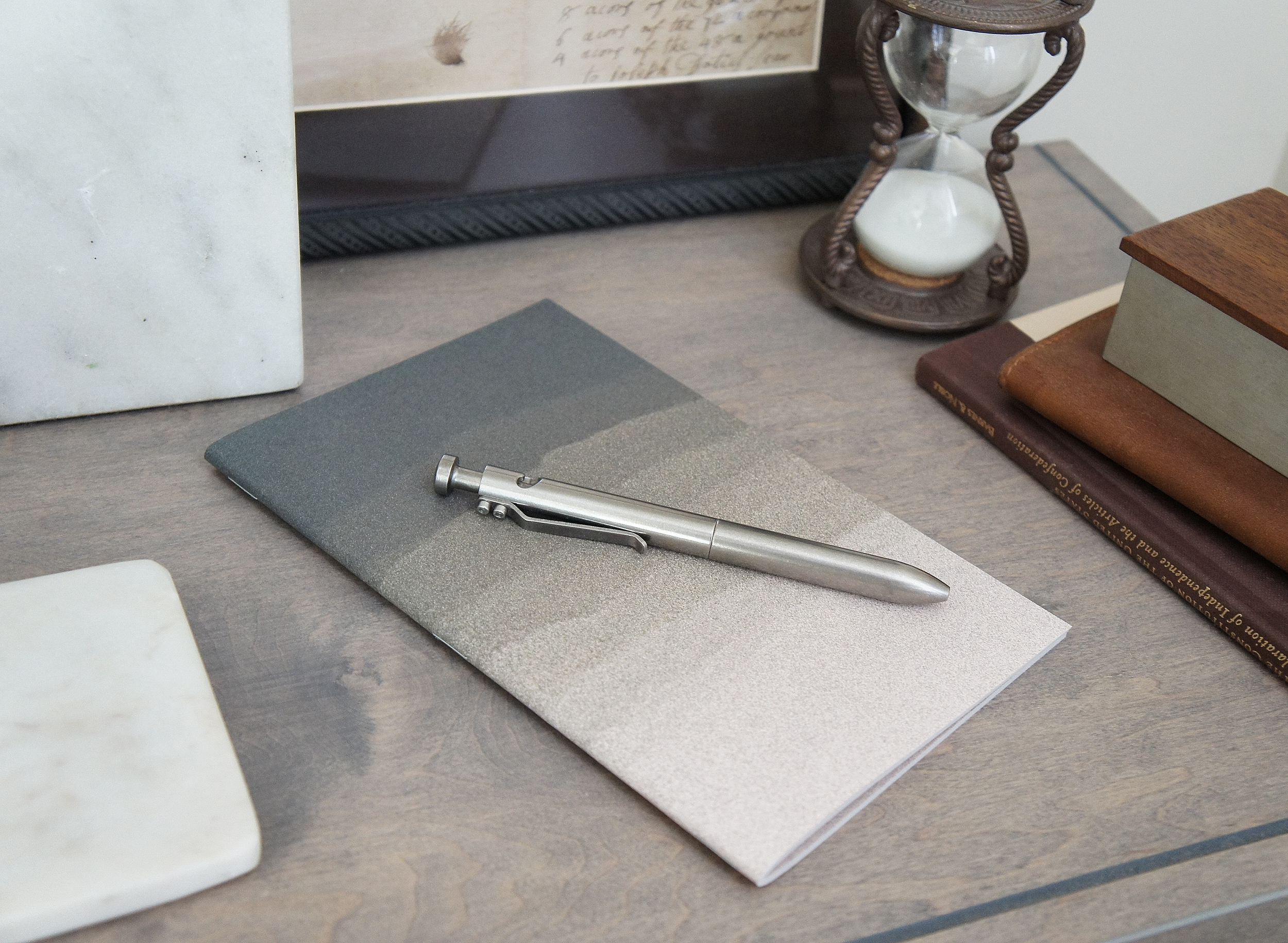 The depiction of a sandy dune adorns the outside of a 5 inch by 7 inch softcover journal, handmade in New London, New Hampshire by the Munk Mint