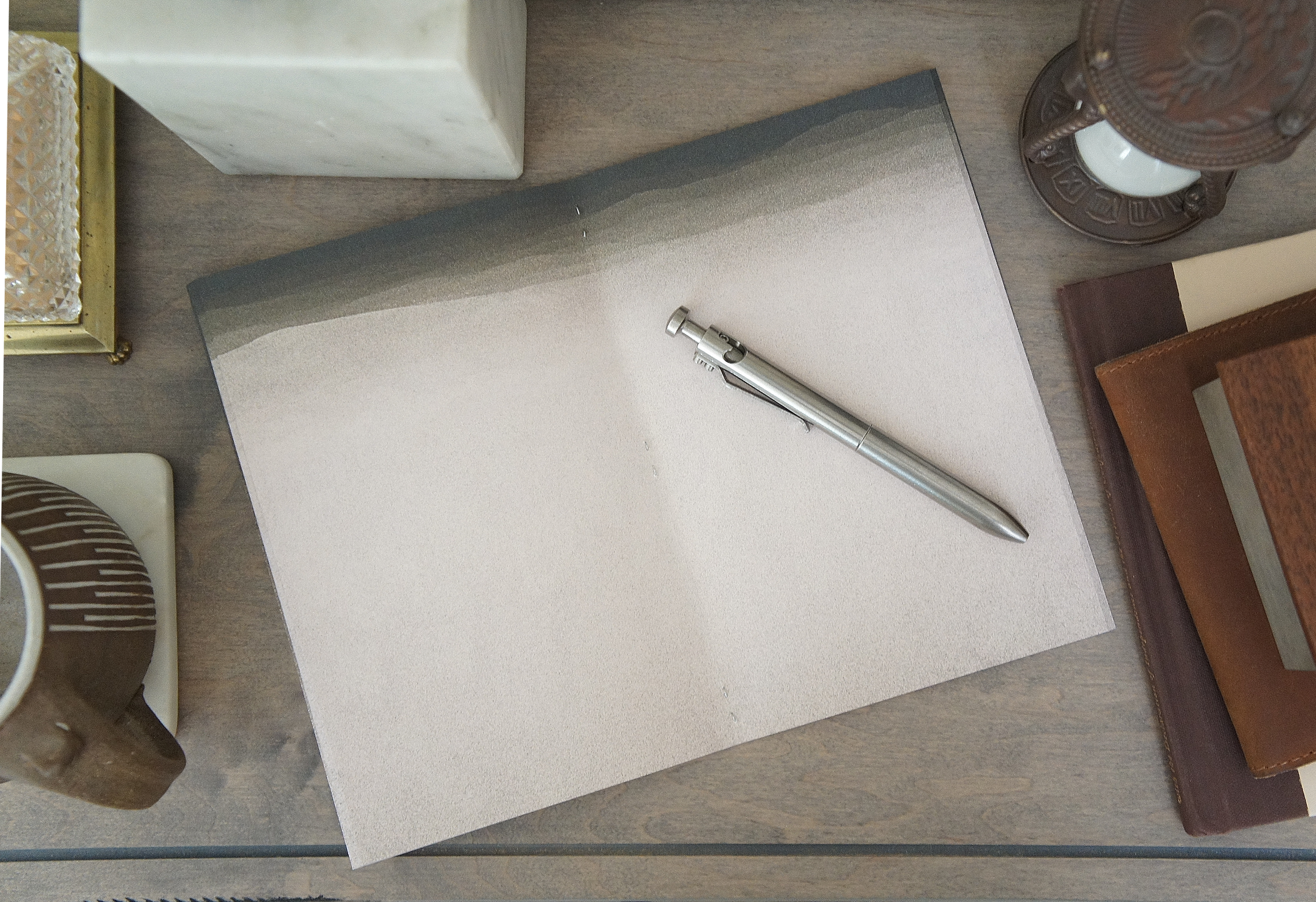 The texture of sand covers the inside of a 5 inch by 7 inch softcover journal, handmade in New London, New Hampshire by the Munk Mint