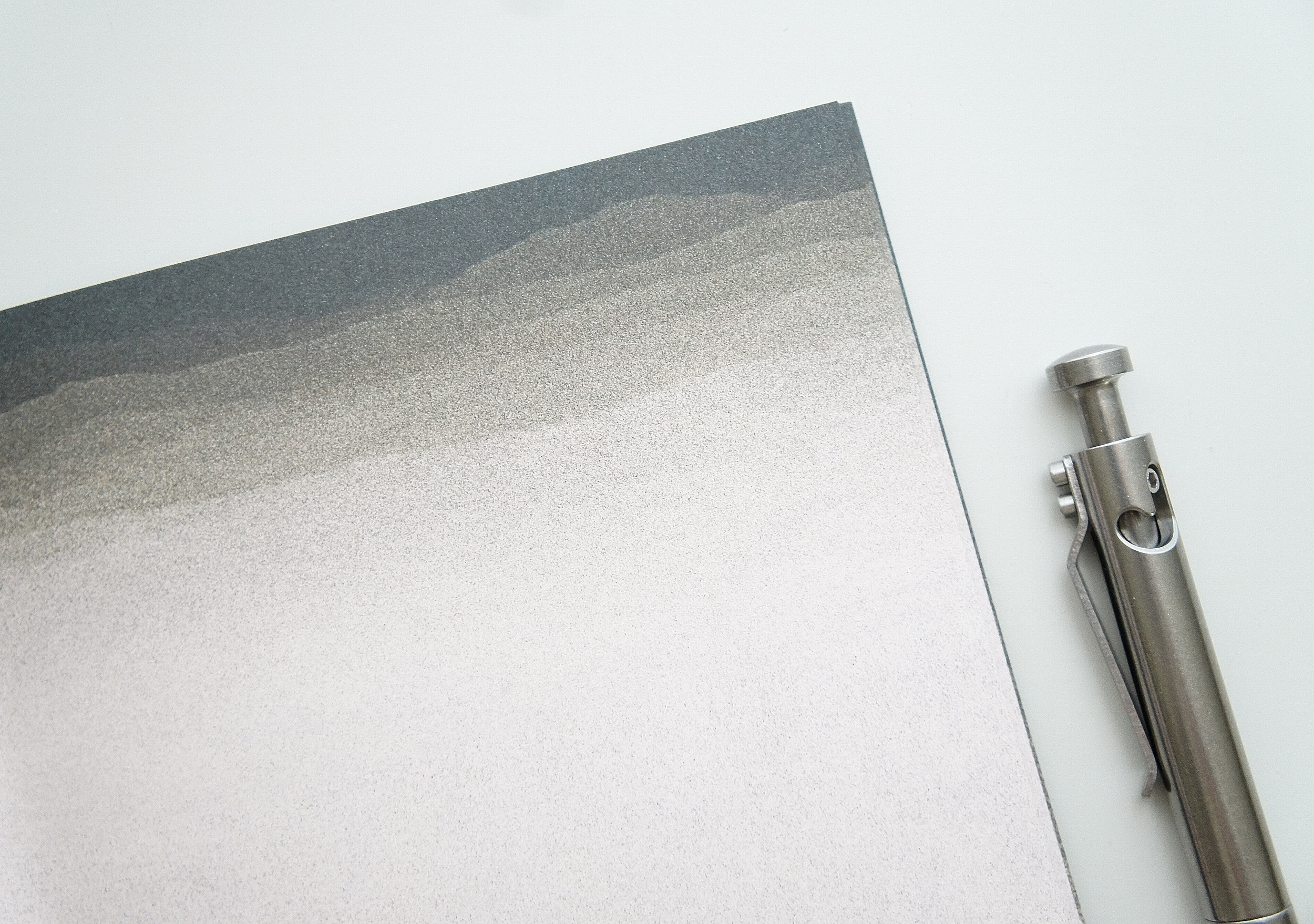 The texture of sand covers the inside of a 5 inch by 7 inch softcover journal, handmade in New London, New Hampshire by the Munk Mint