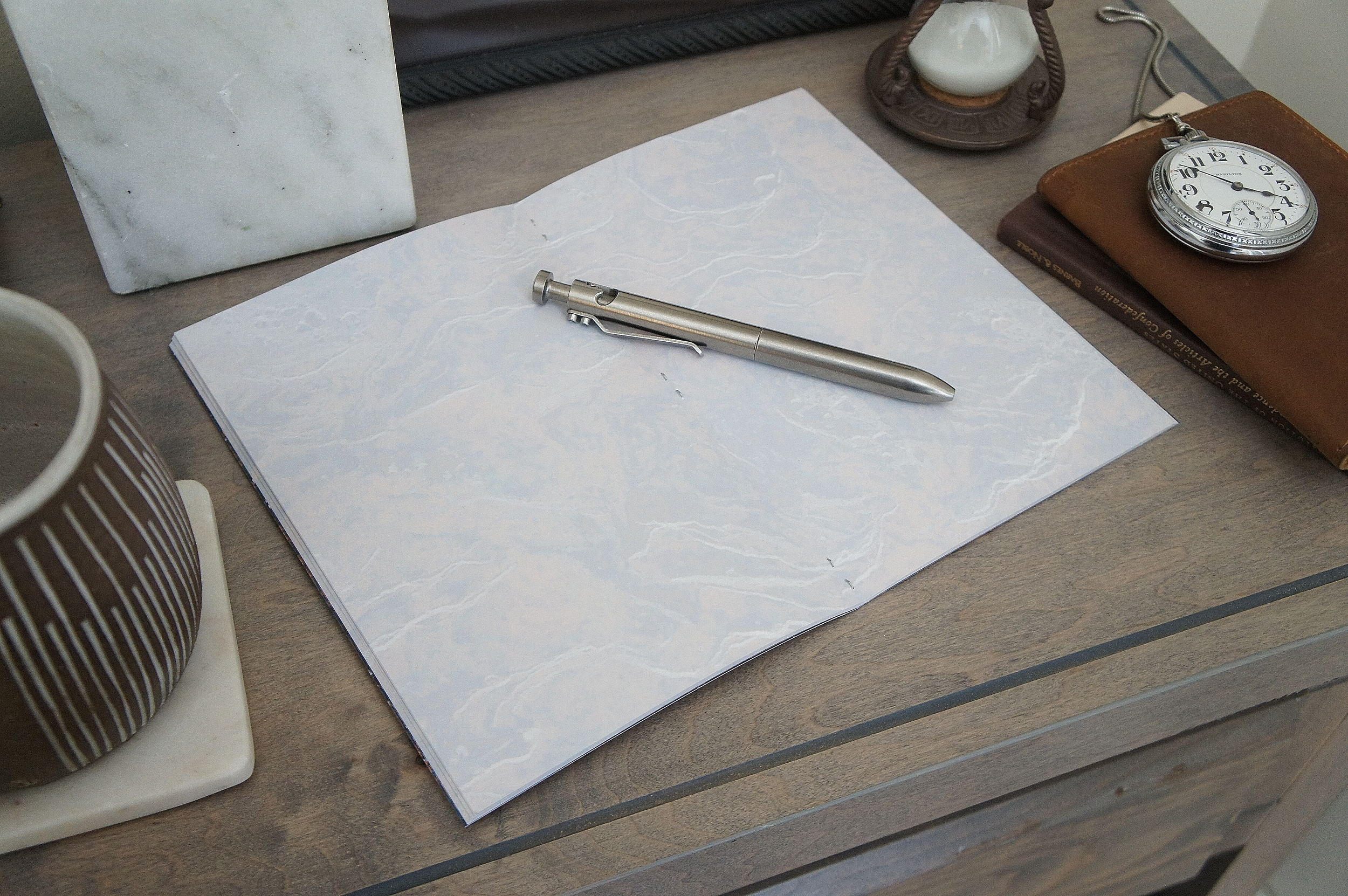 The texture of stone covers the inside of a 5 inch by 7 inch softcover journal, handmade in New London, New Hampshire by the Munk Mint