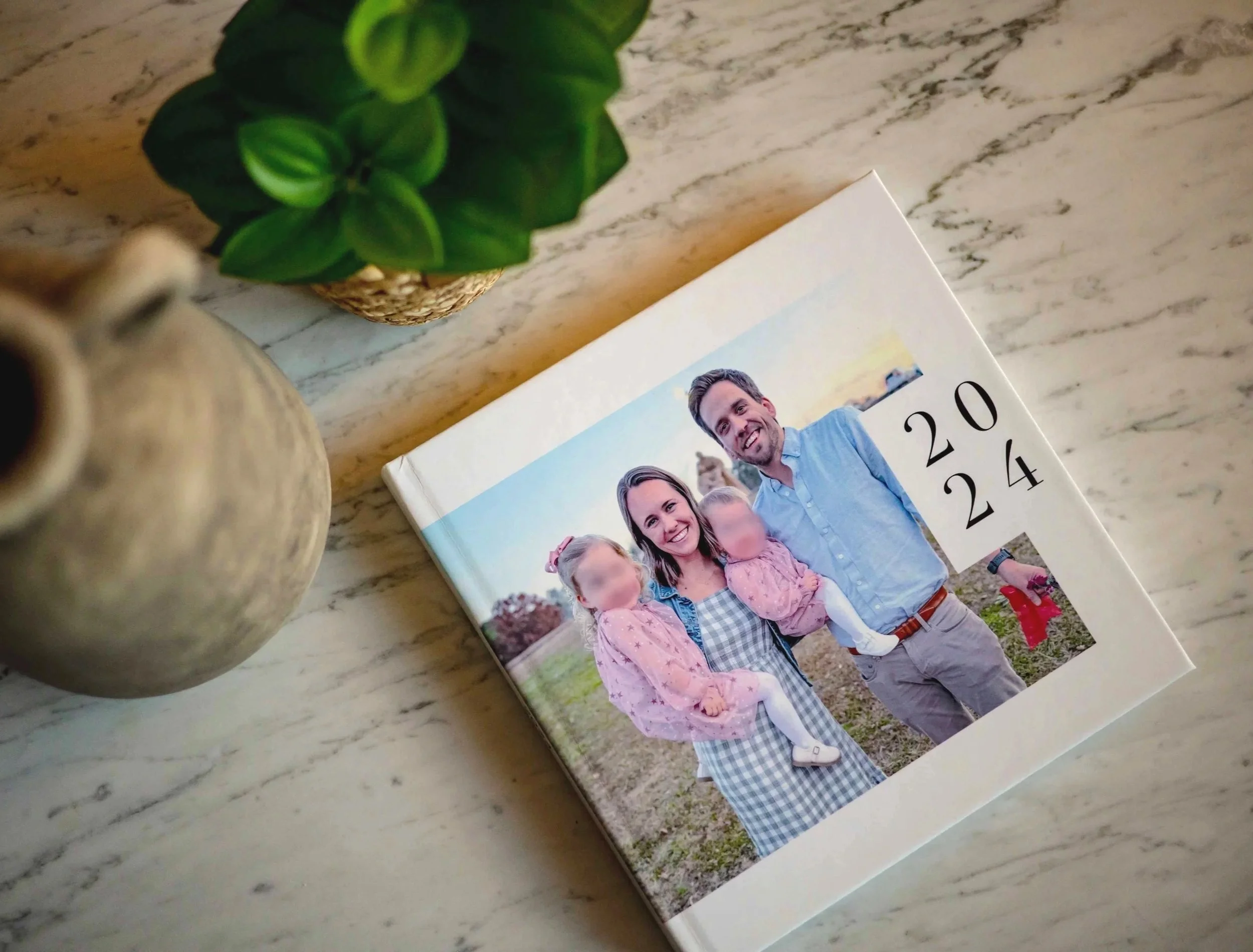 A book cover featuring a family photo, with two adults and two children, outdoors at sunset. The cover displays the year "2024" in large black numbers.