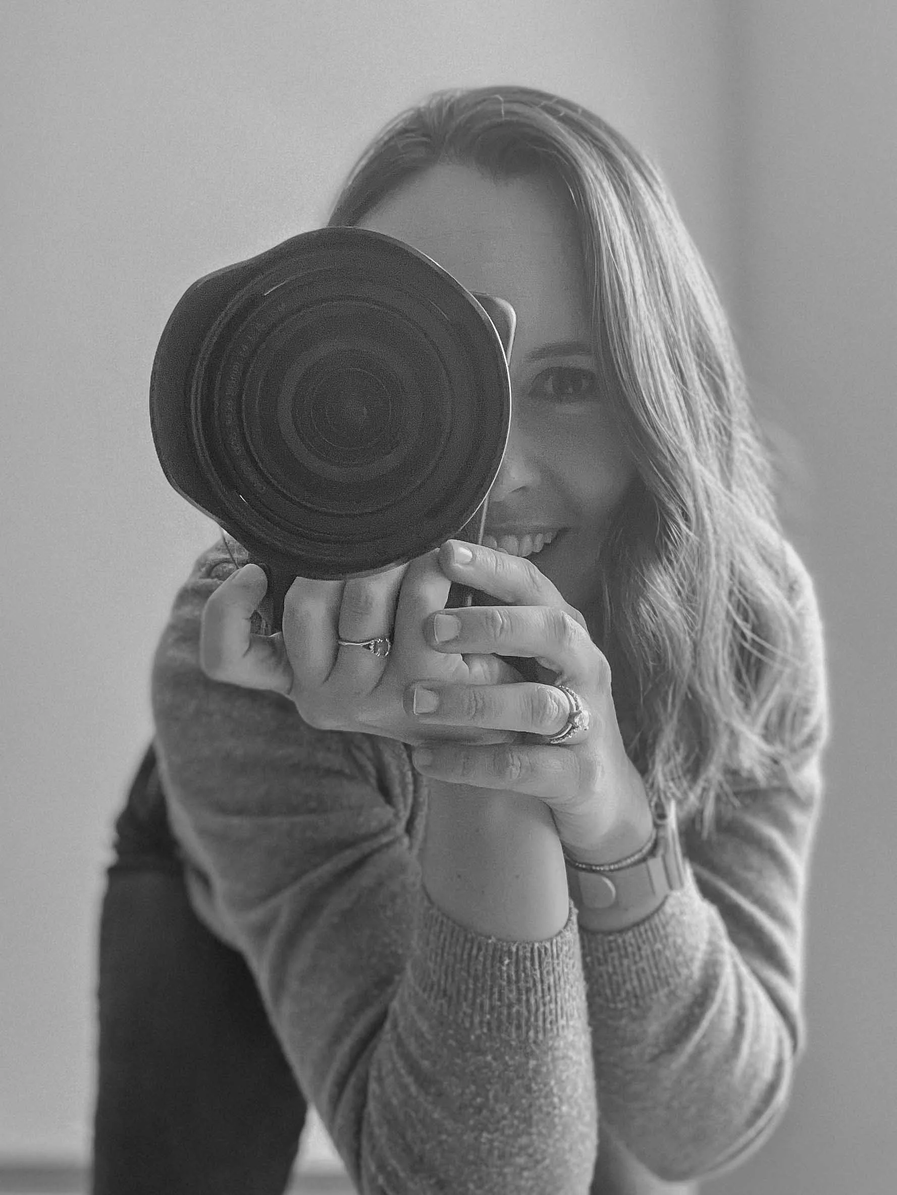 Photographer biography picture holding camera