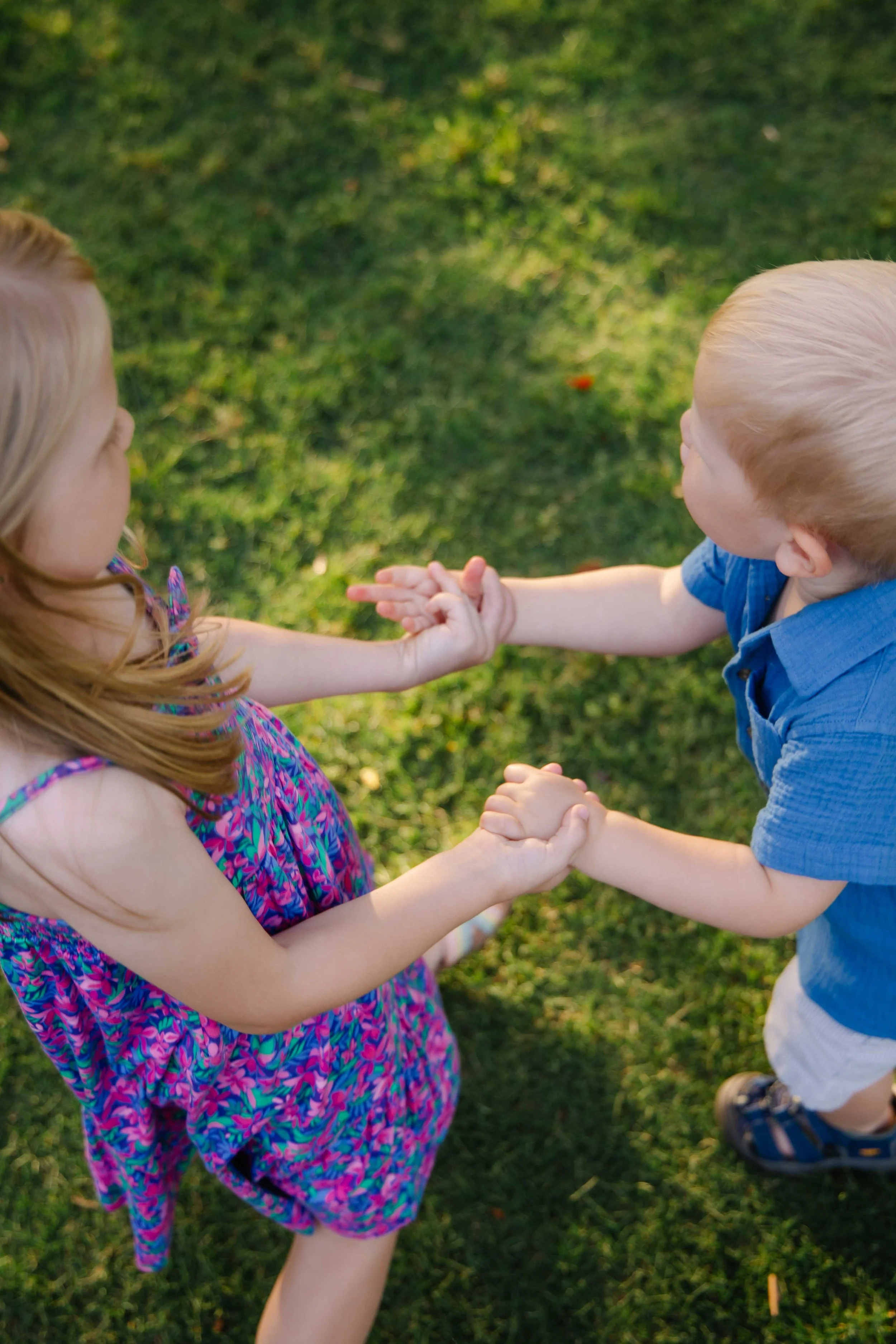 Two kids holding hands while dancing