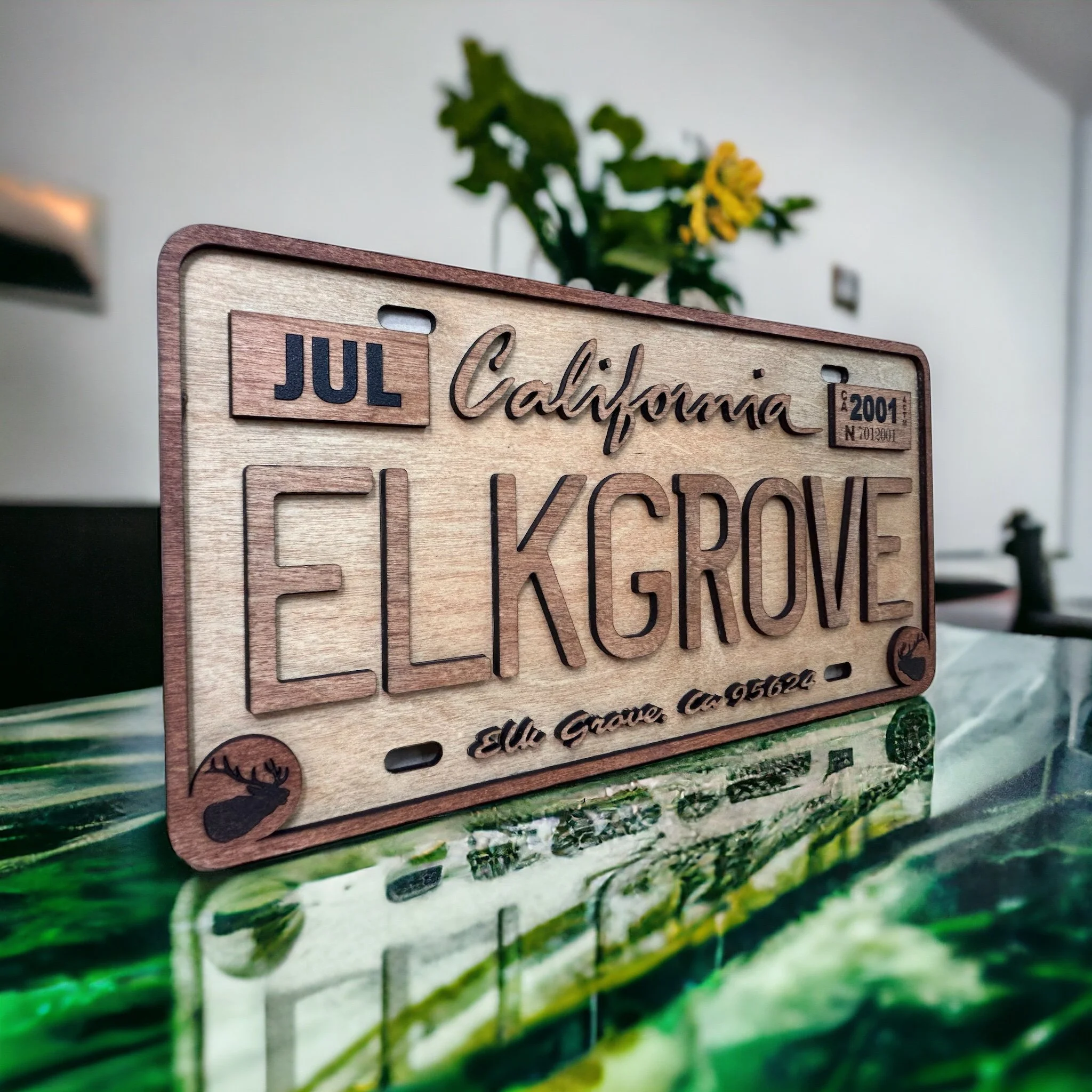 Wooden California inspired license plate, stained with the name of a city on it, "Elk Grove"