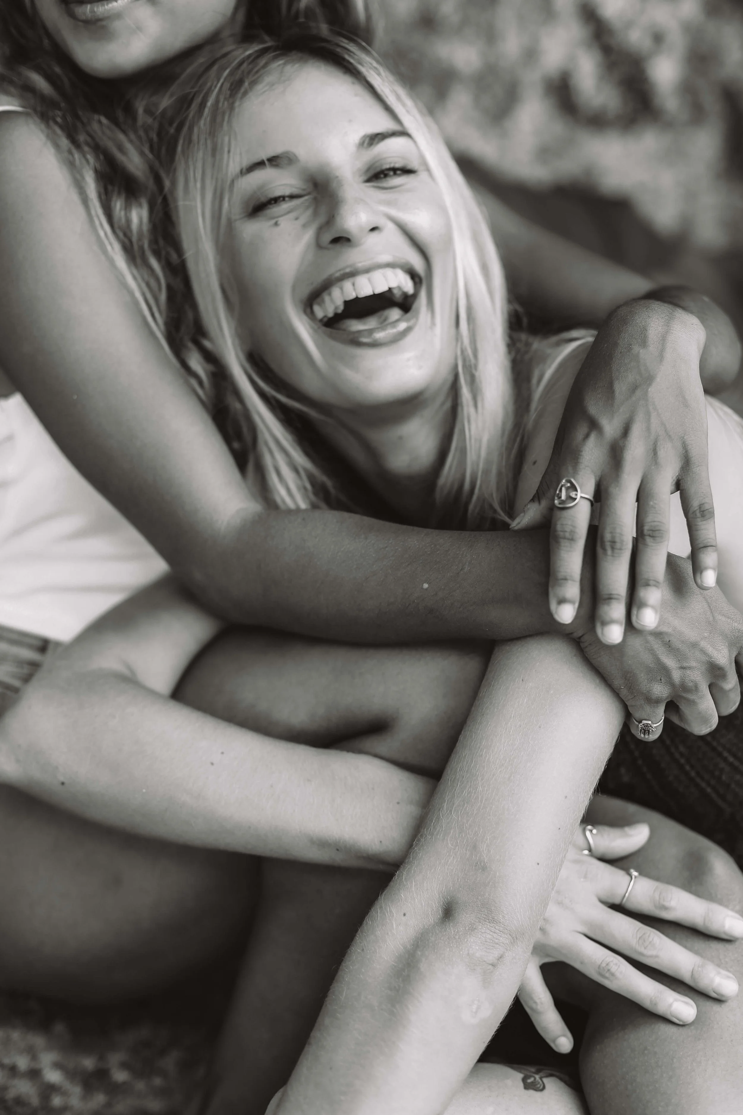 Woman laughing with loved ones, supported and cared for