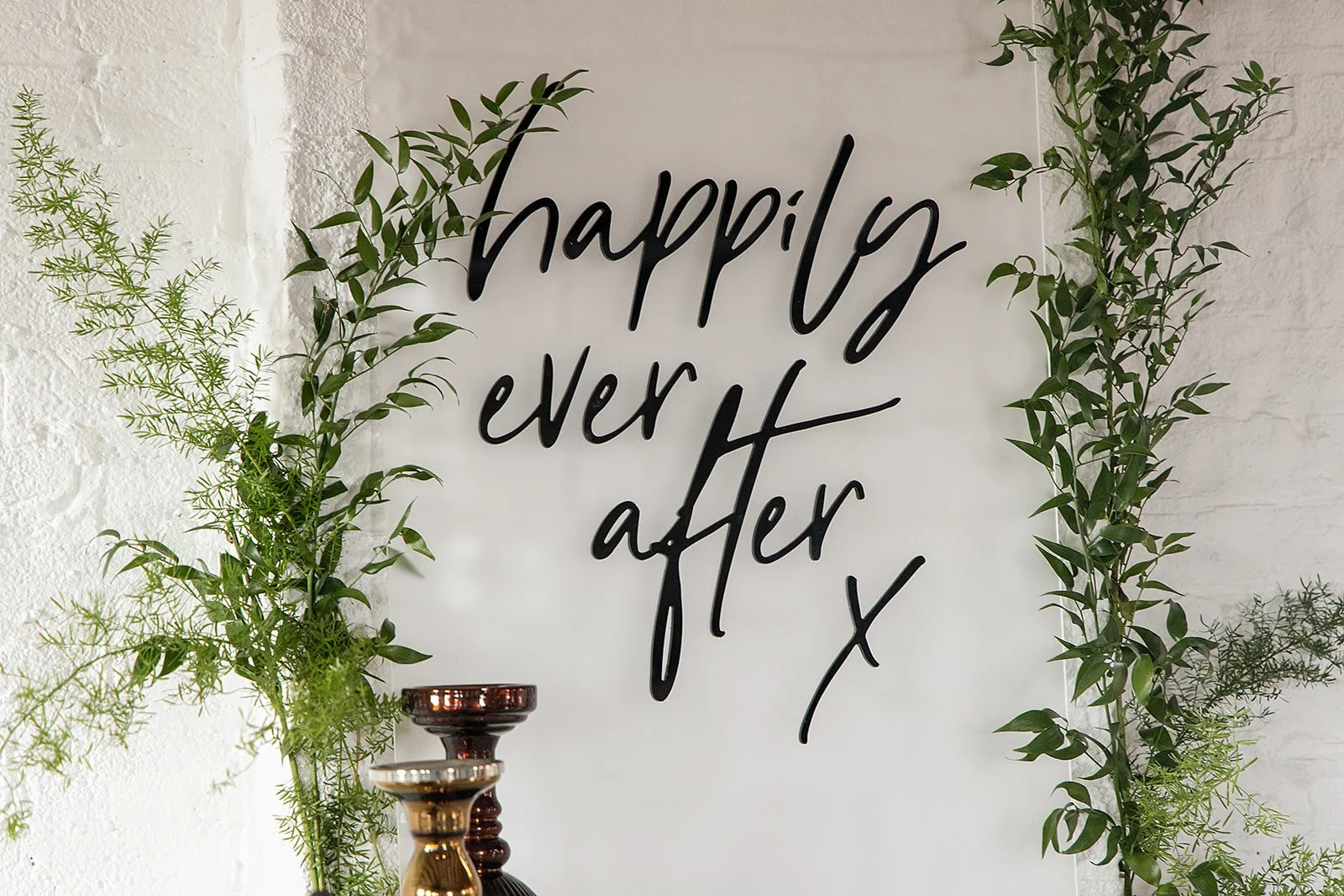 Decorative sign with the words 'happily ever after' greeting guests at a Braestone Farm Wedding in Oro-Medonte.