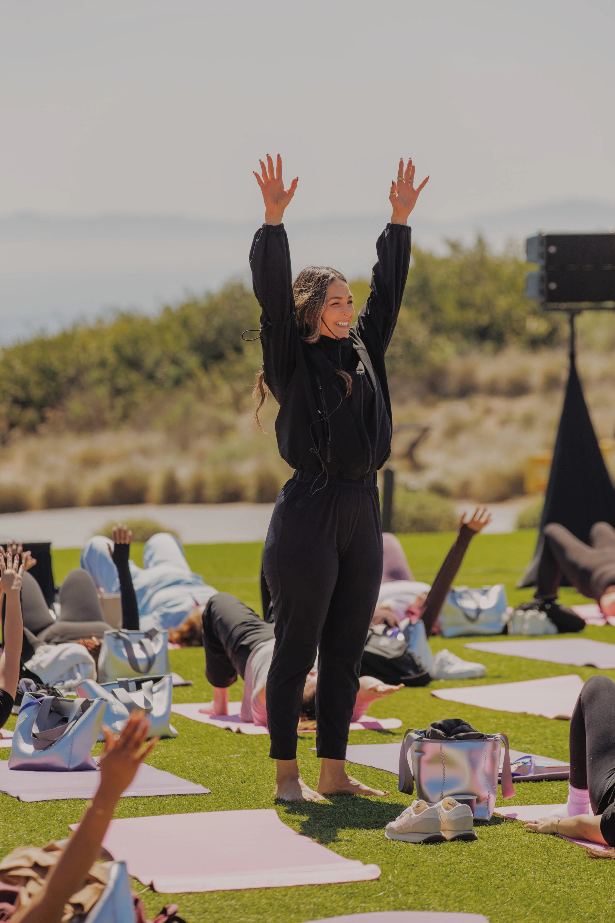 Rosie Acosta teaching mindfulness and meditation practices to a large group of attendees at FEMME Summit.
