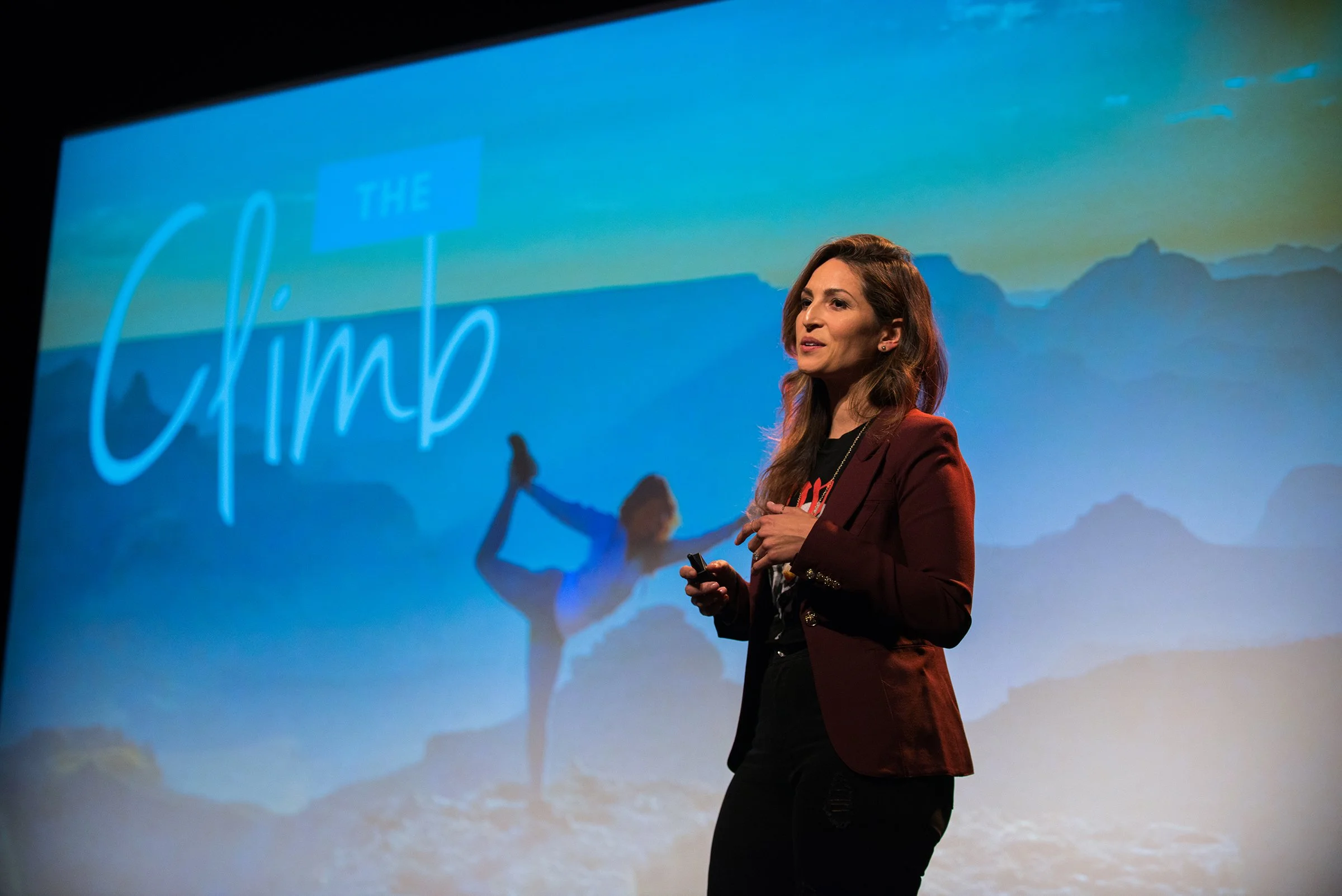 Rosie Acosta speaking about emotional resilience, mindfulness, and personal transformation during a keynote presentation.