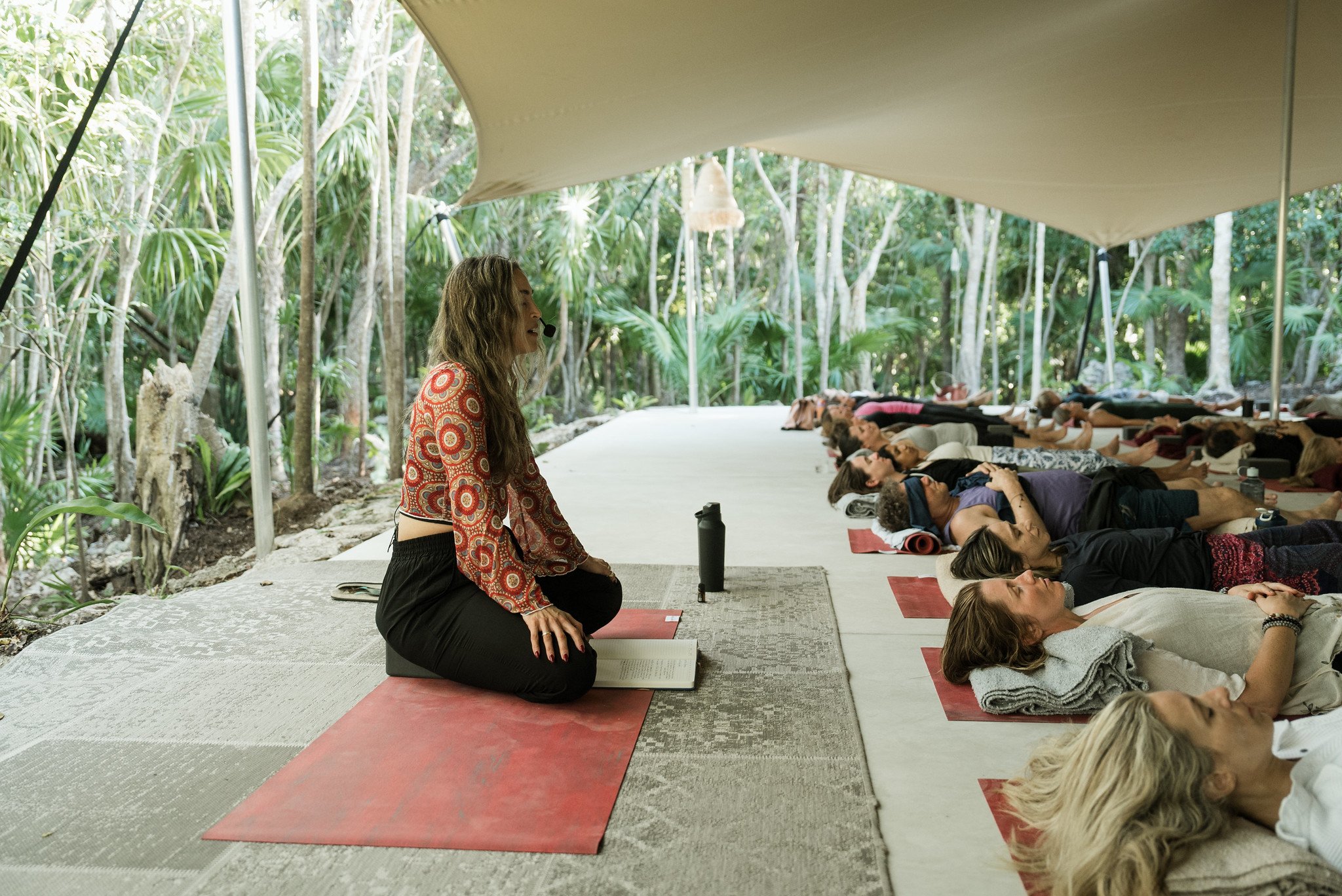 Rosie Acosta leading a guided meditation and savasana mindfulness practice at Palmaïa The House of AïA in Mexico.
