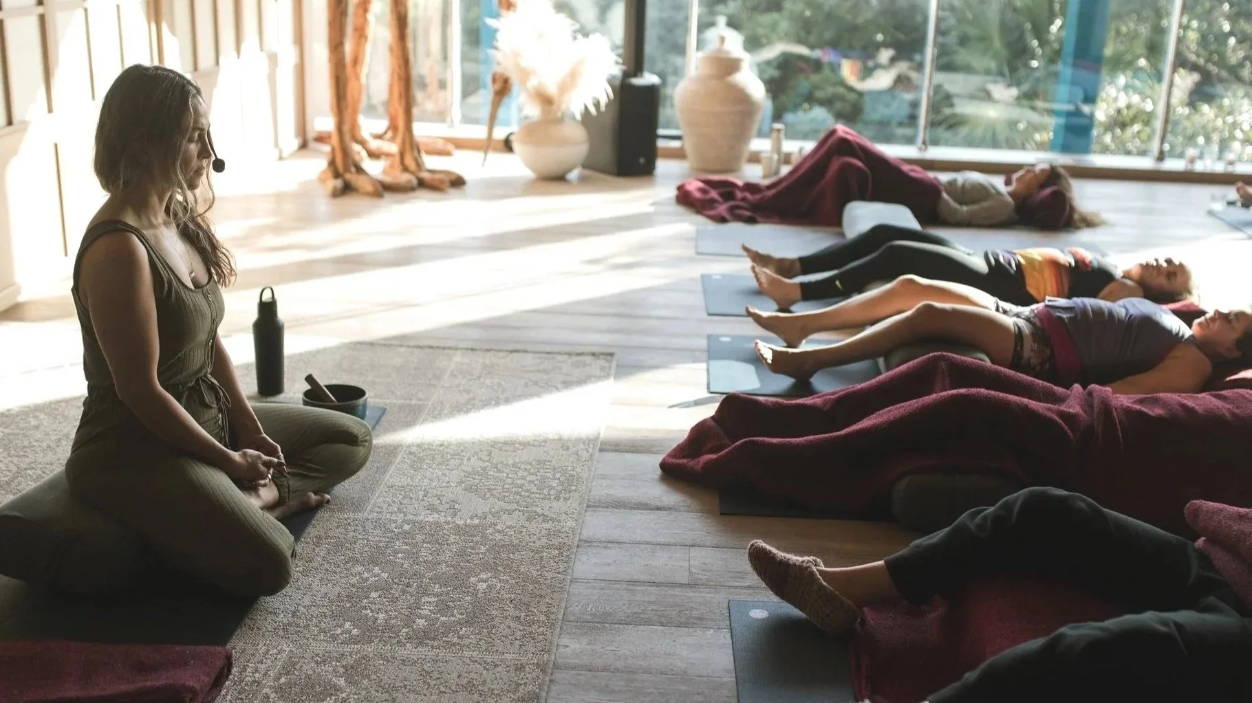 Rosie Acosta guides a mindfulness meditation on burnout recovery and emotional resilience during Wanderlust Palmaia in Mexico.
