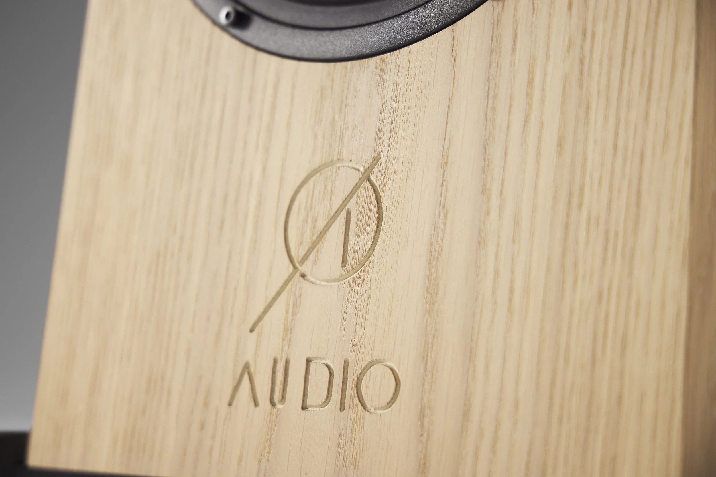 Close up detail of engraved Ø Audio logo on the base of an Icon 12 loudspeaker